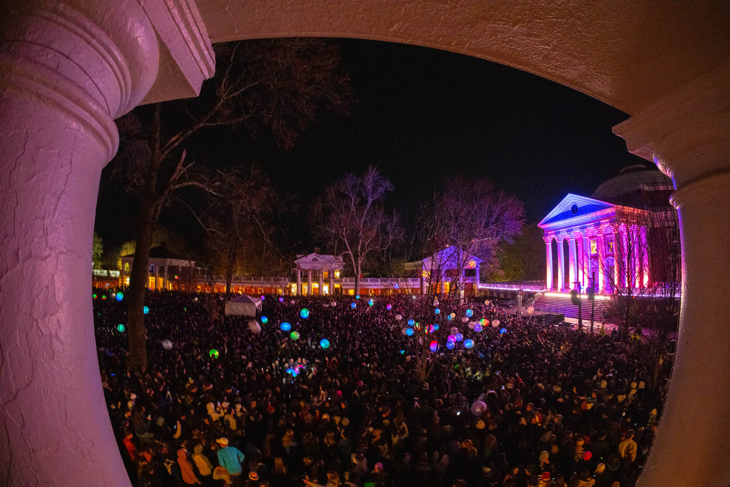 View of the lawn filled with people lit up in multiple colors