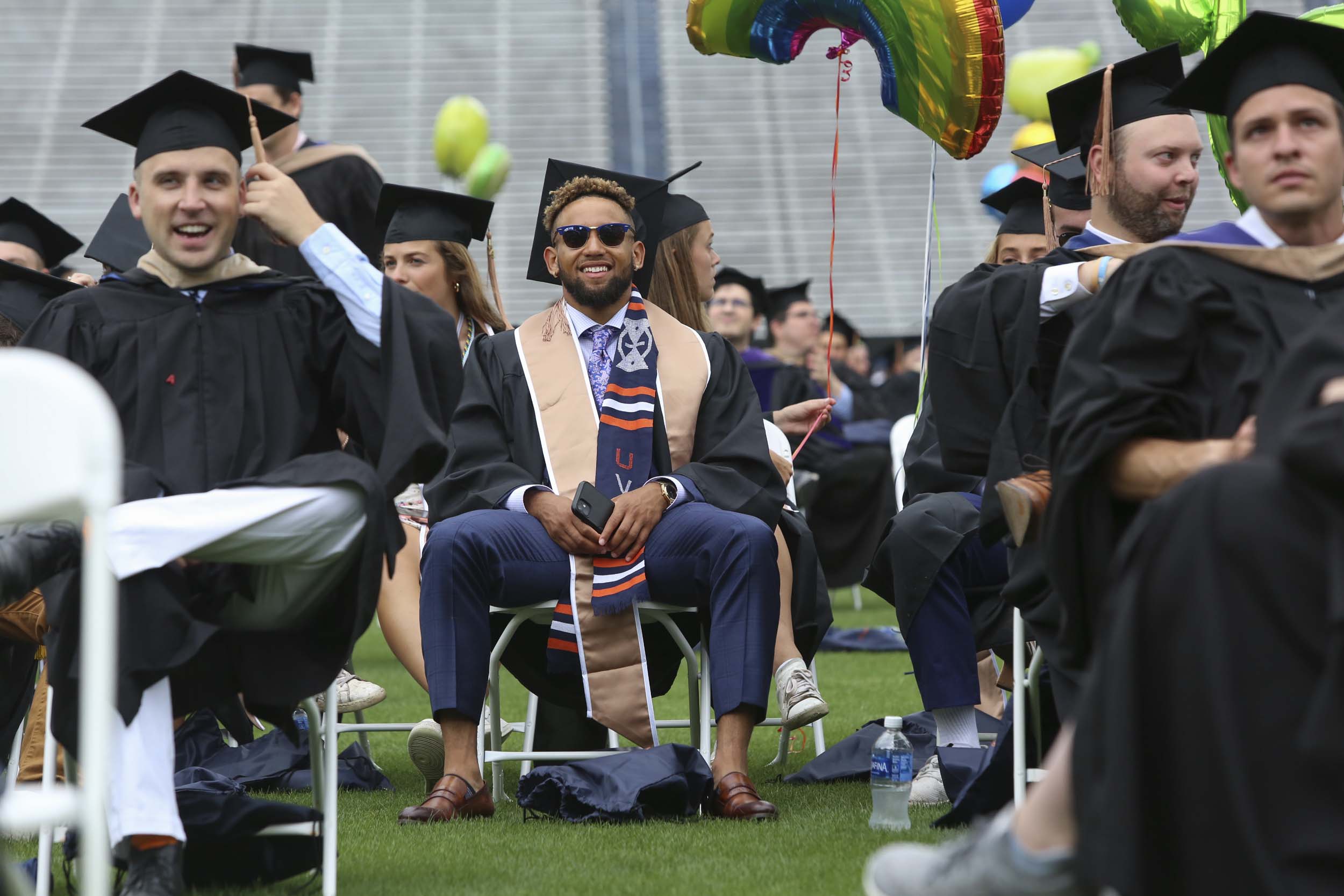 Graduates sitting in socially distanced chairs