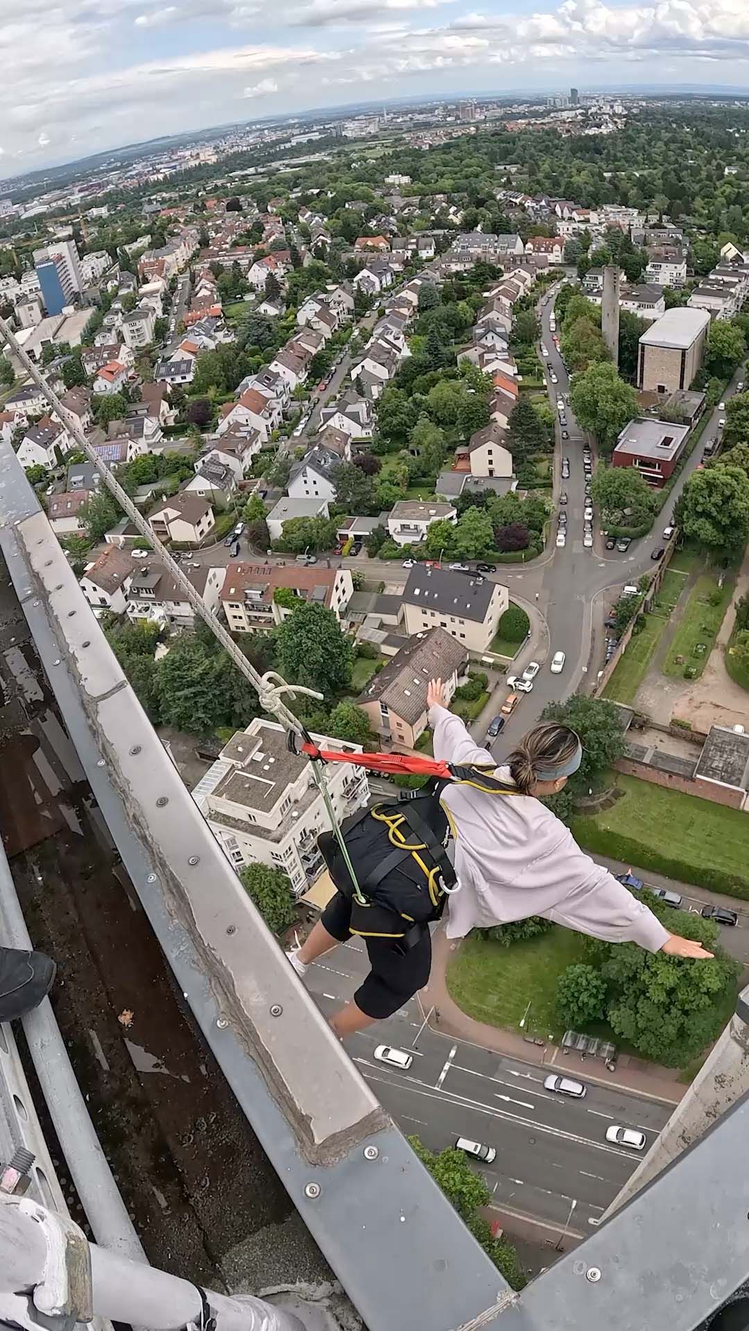 Khuyen hanging from a 27 story building