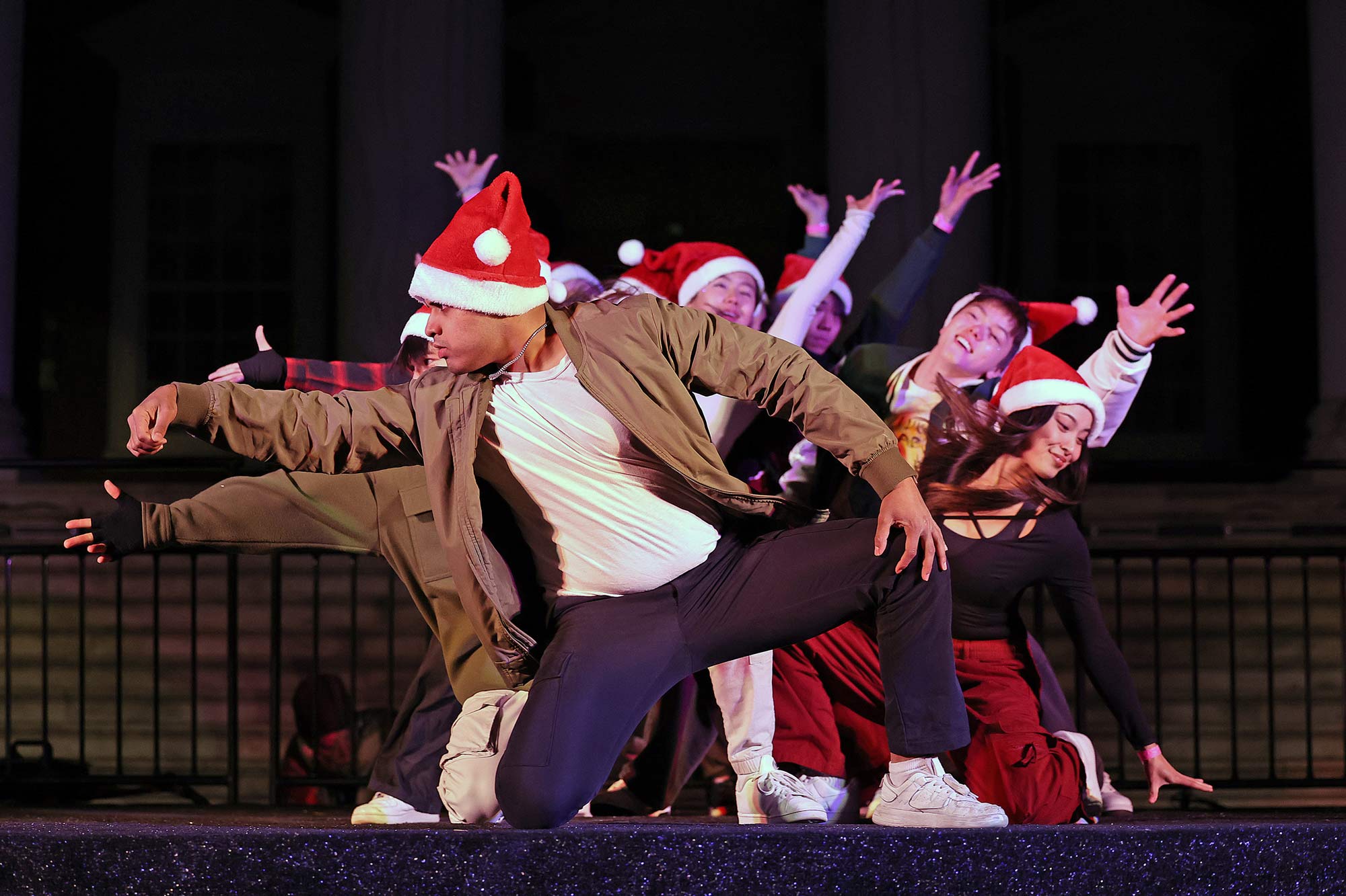 Dancers jump out from behind each other for a holiday dance routine