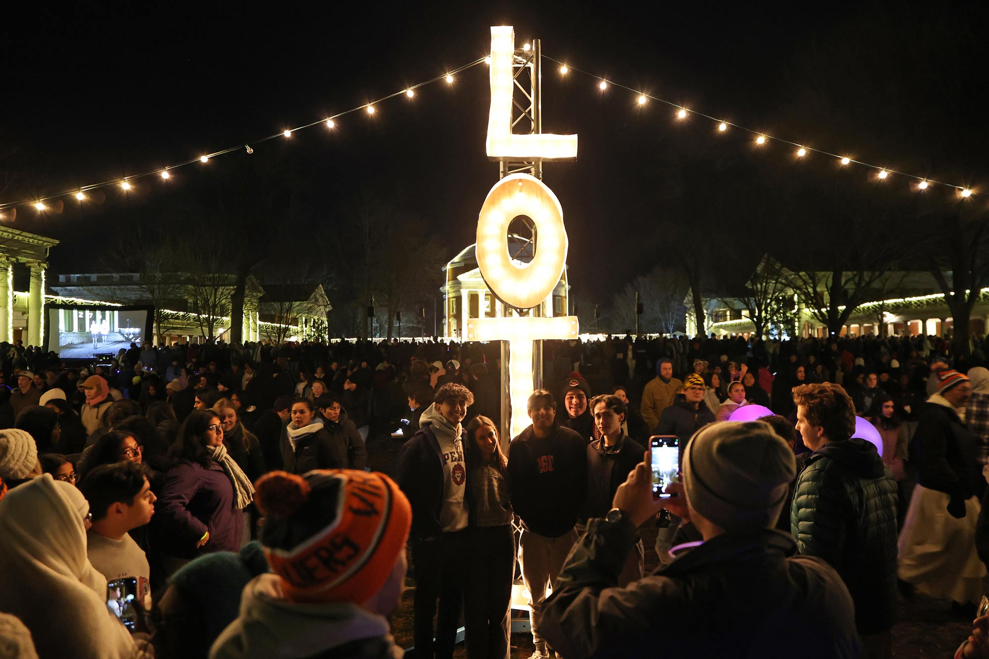 A crowd gathers in front of the "LOTL" sign to take pictures