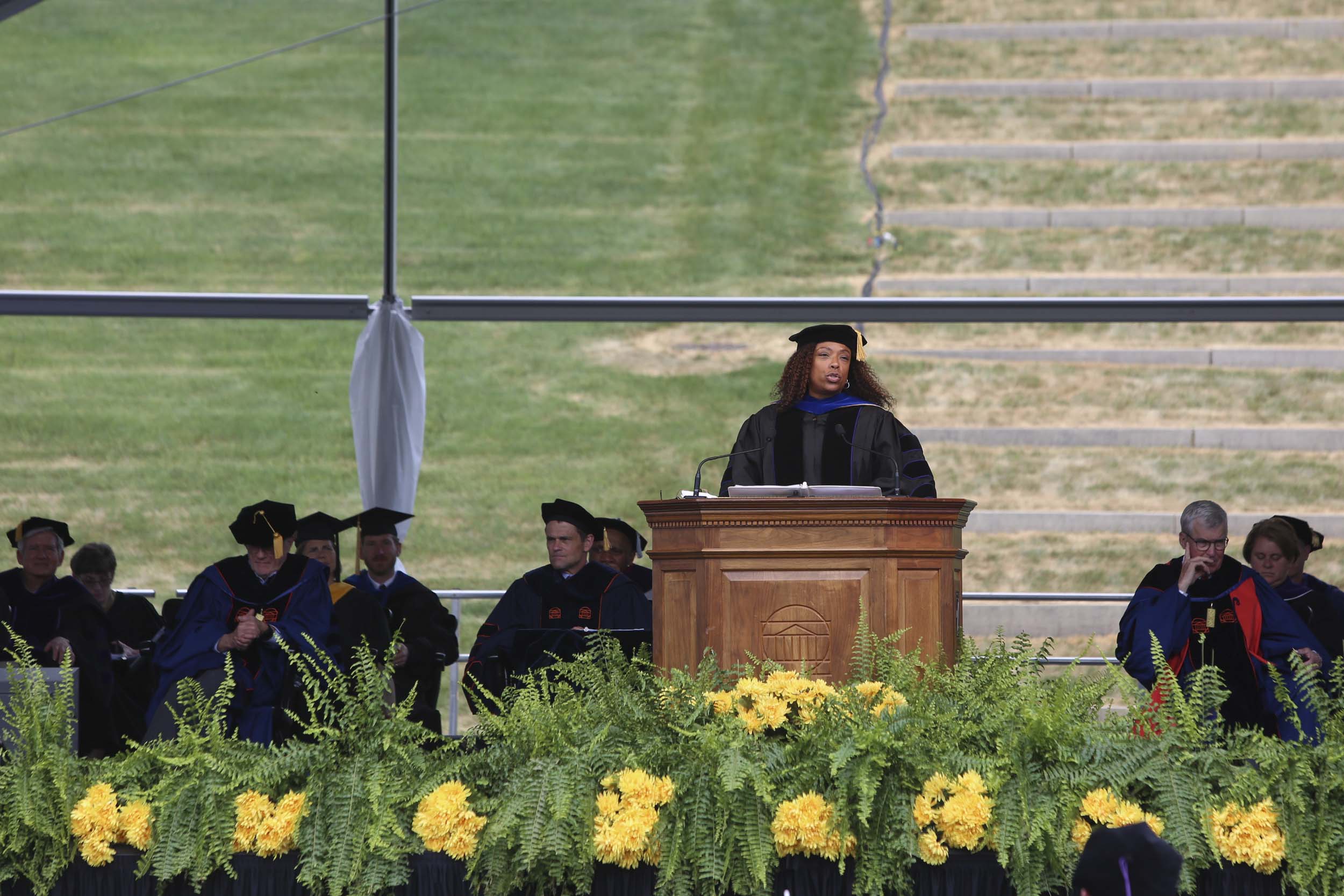 Graduation speaker standing at a big wooden podium