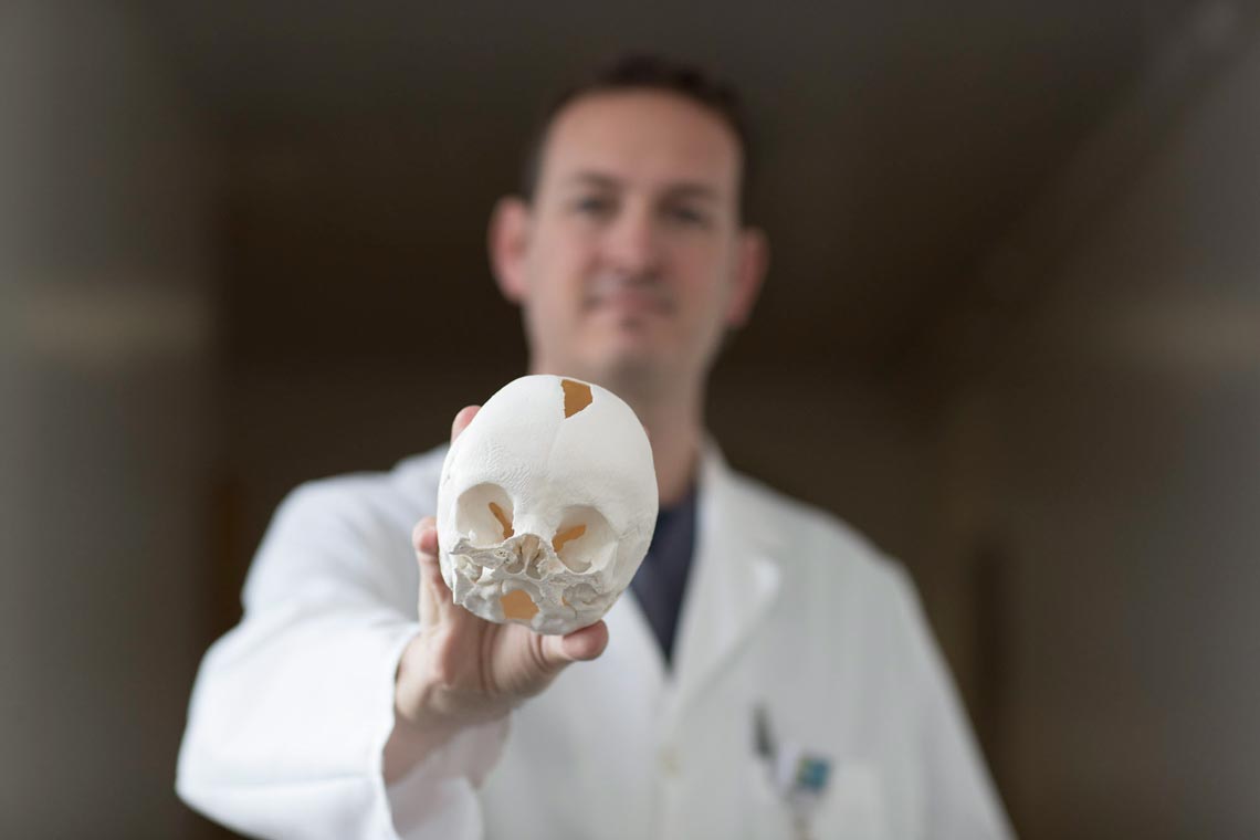 Johnathan Black holds a skull