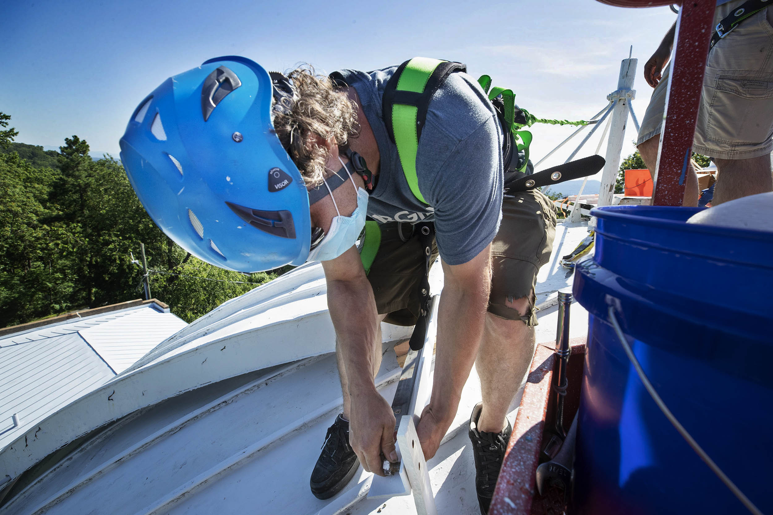 Peter Dow bolts a shutter in place on the Observatory Dome
