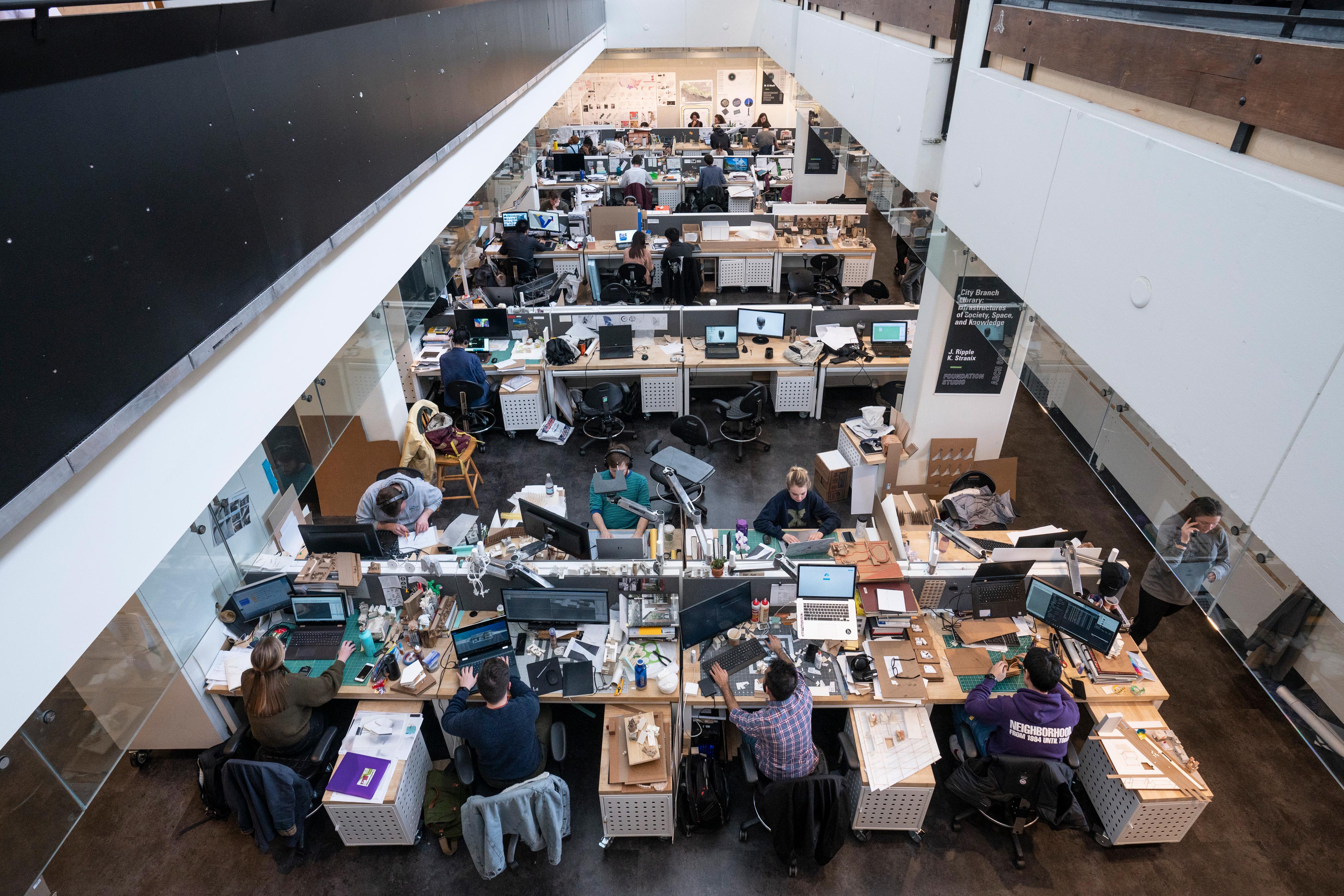 Overhead view of a busy architecture workspace.