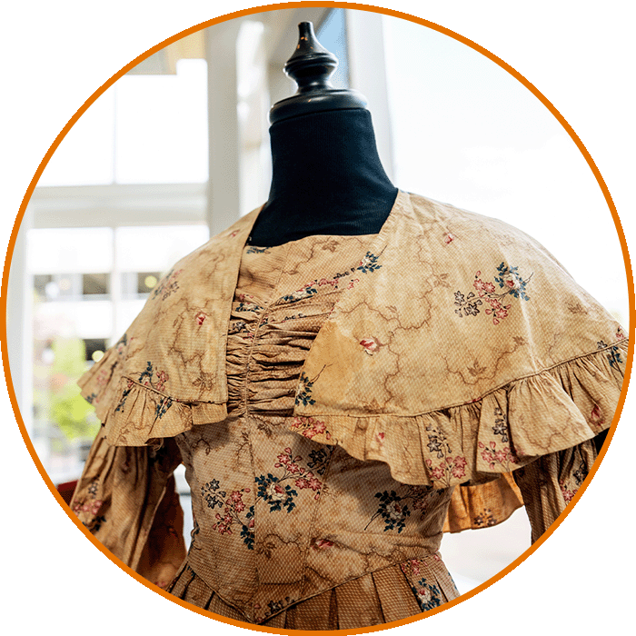 Close up of the dress from 1837 showing the detailed stitching on the bust.