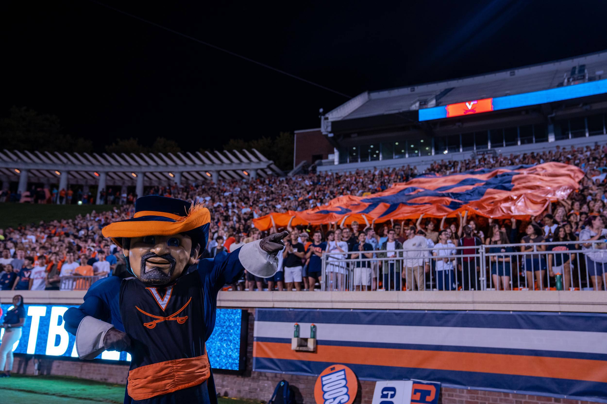 The Cavman in front of a crowd of studnets in Scott Stadium