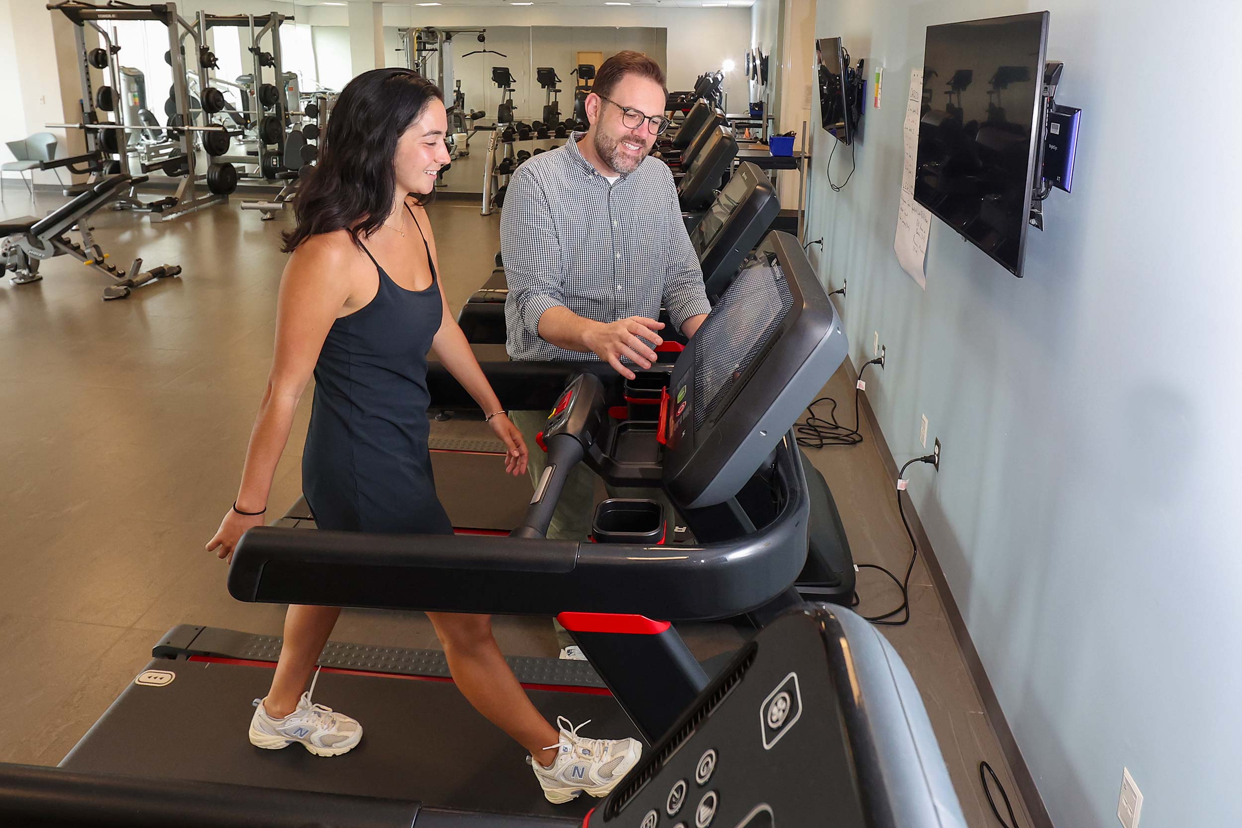 Chris Kuenze monitors Candence Layne as she walks on a treadmill during ACL surgery recovery.