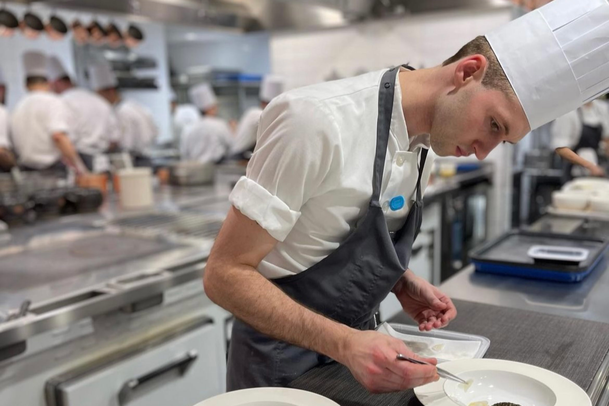 A candid portrait of Chef Charles Verheggen preparing a dish.