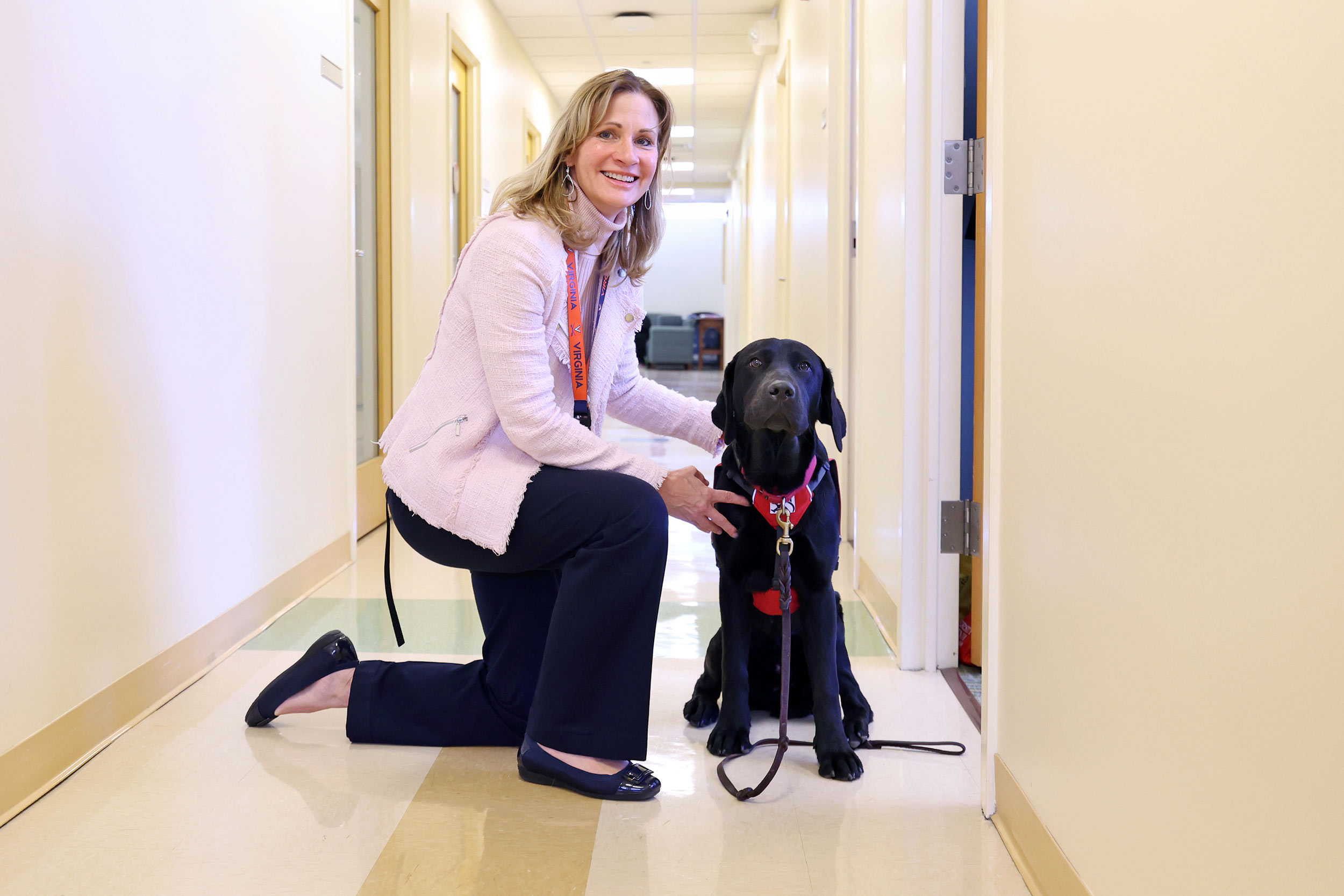 Portrait of Beth Quatrara with a service dog.