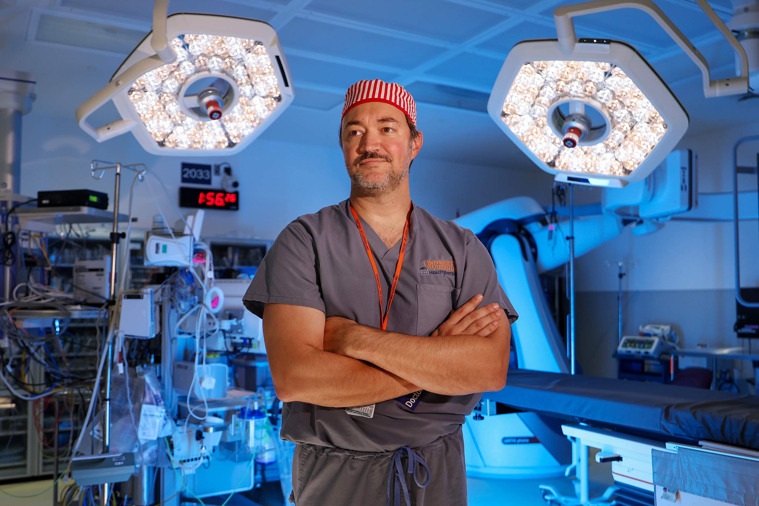 Dr. Jade Nunez standing with his arms crossed in an operating room