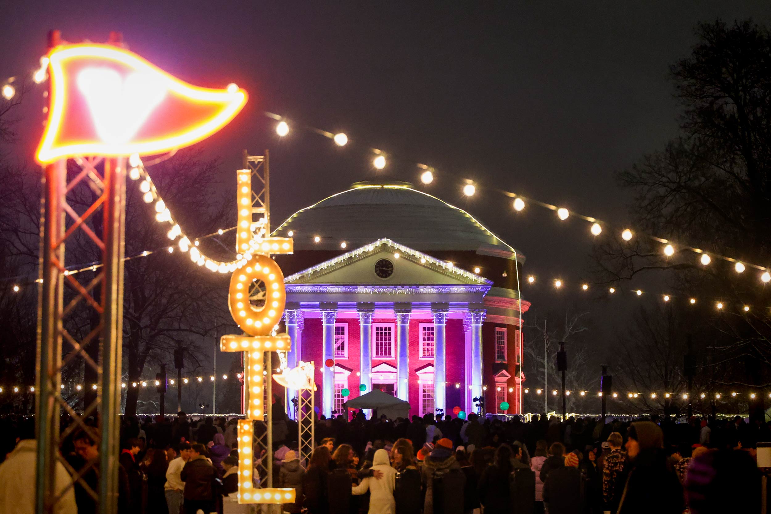 a crowd of students gather on the Lawn to see the Rotunda illuminated with lights during Lighting of the Lawn 2025
