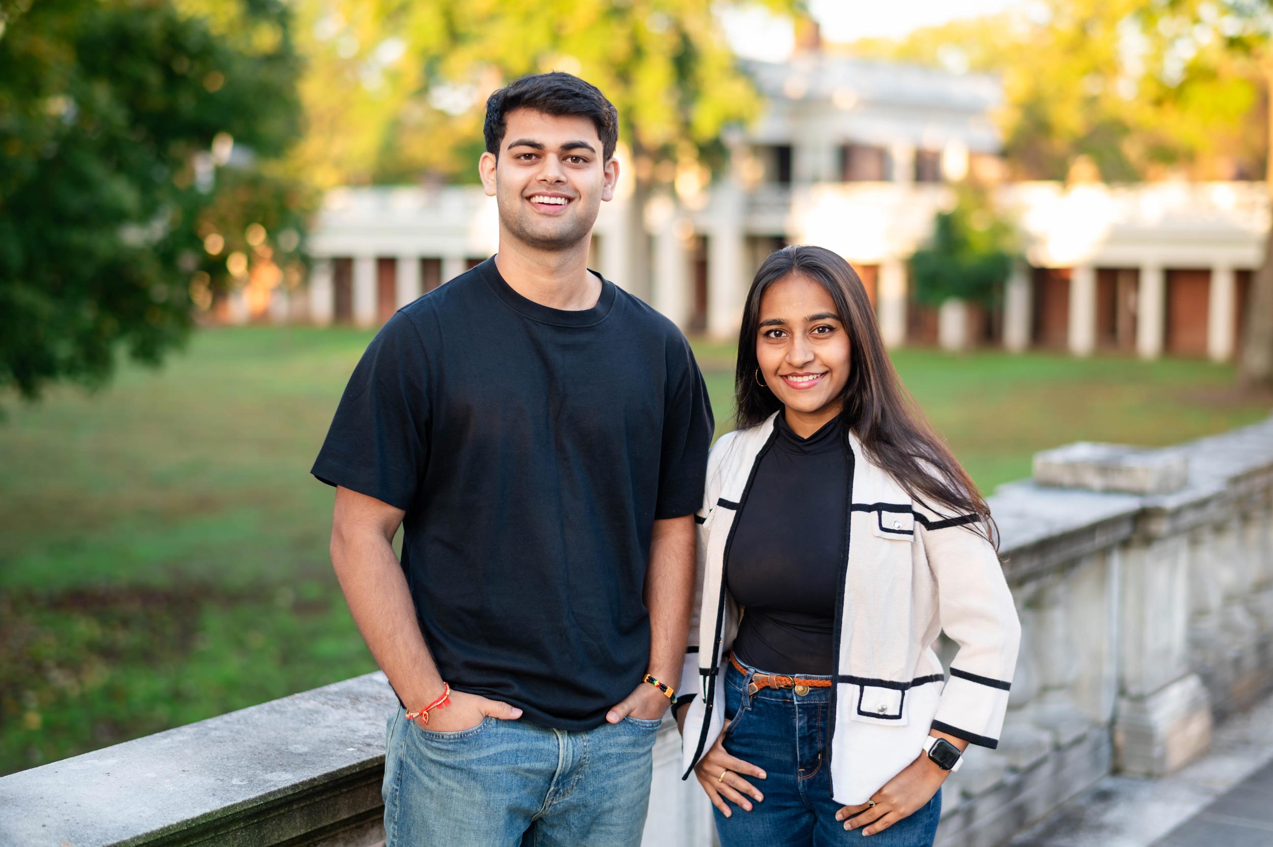 Group portrait of McIntire School of Commerce graduates Manish Dahal and Sarrah Abdulali.