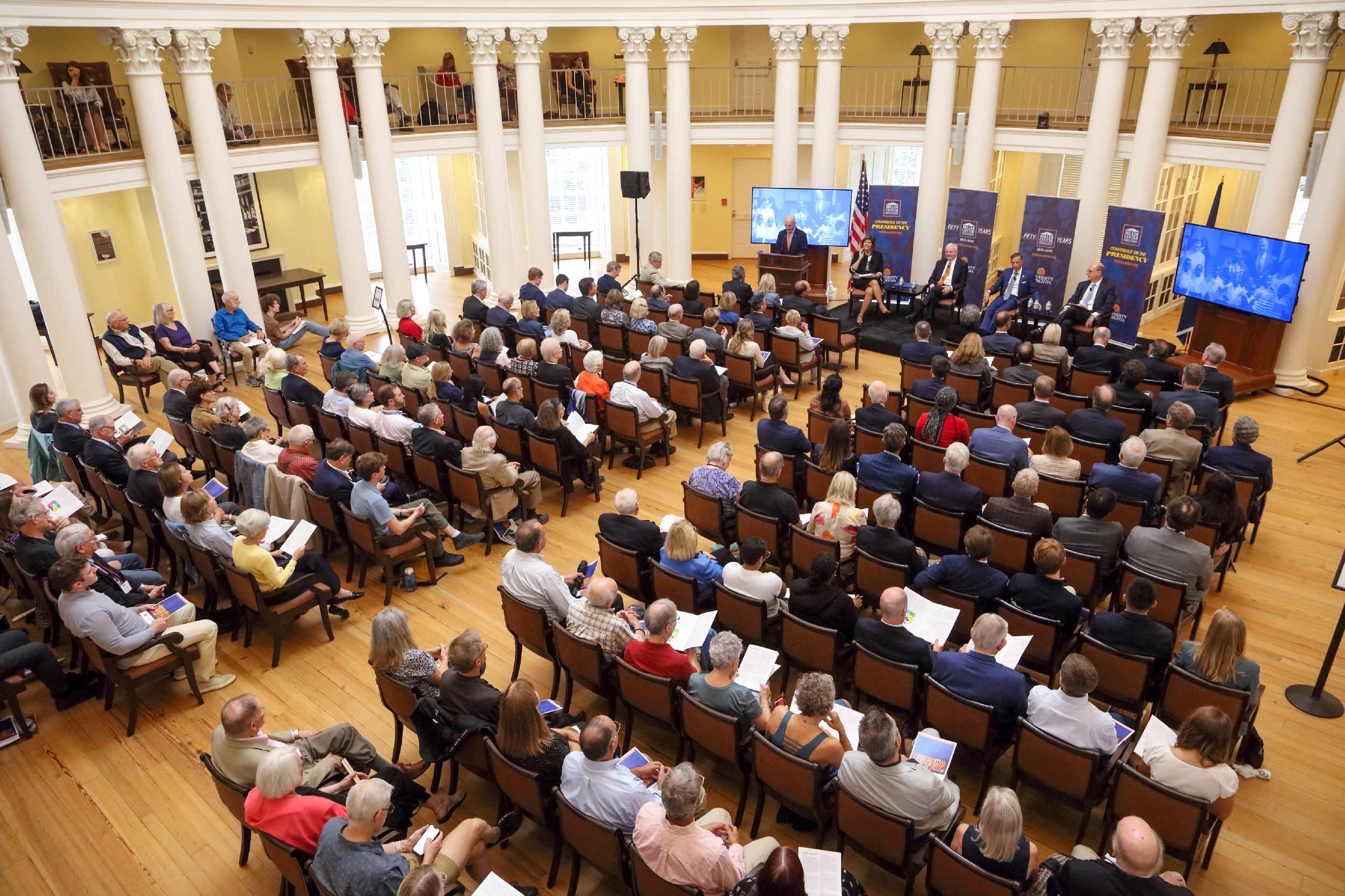 an audience listening to a talk in the UVA Rotunda Dome Room