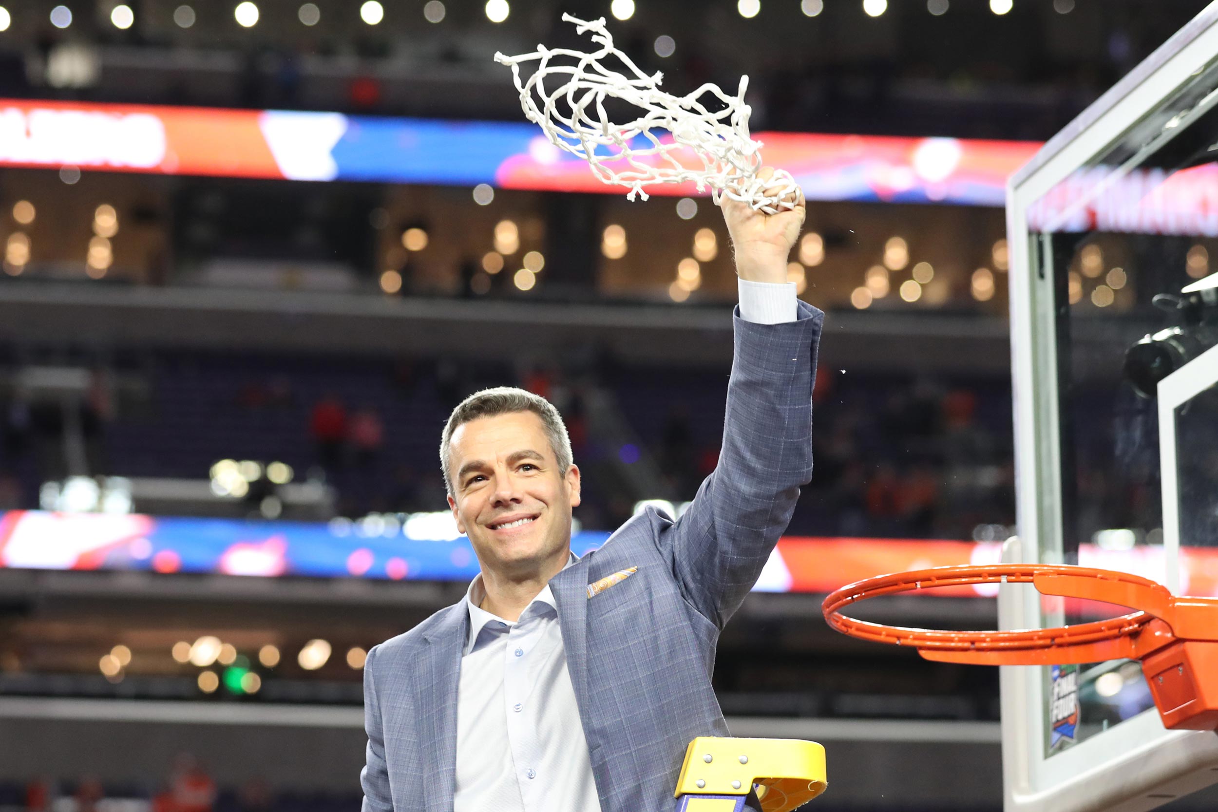 Tony Bennett celebrates after cutting the last strand of the net 