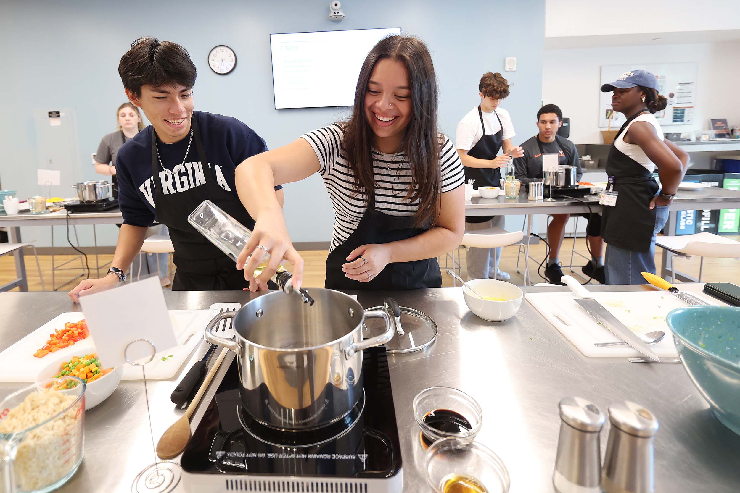 Diego Chavez and Jenny Mejia cooking in the UVA teaching kitchen.