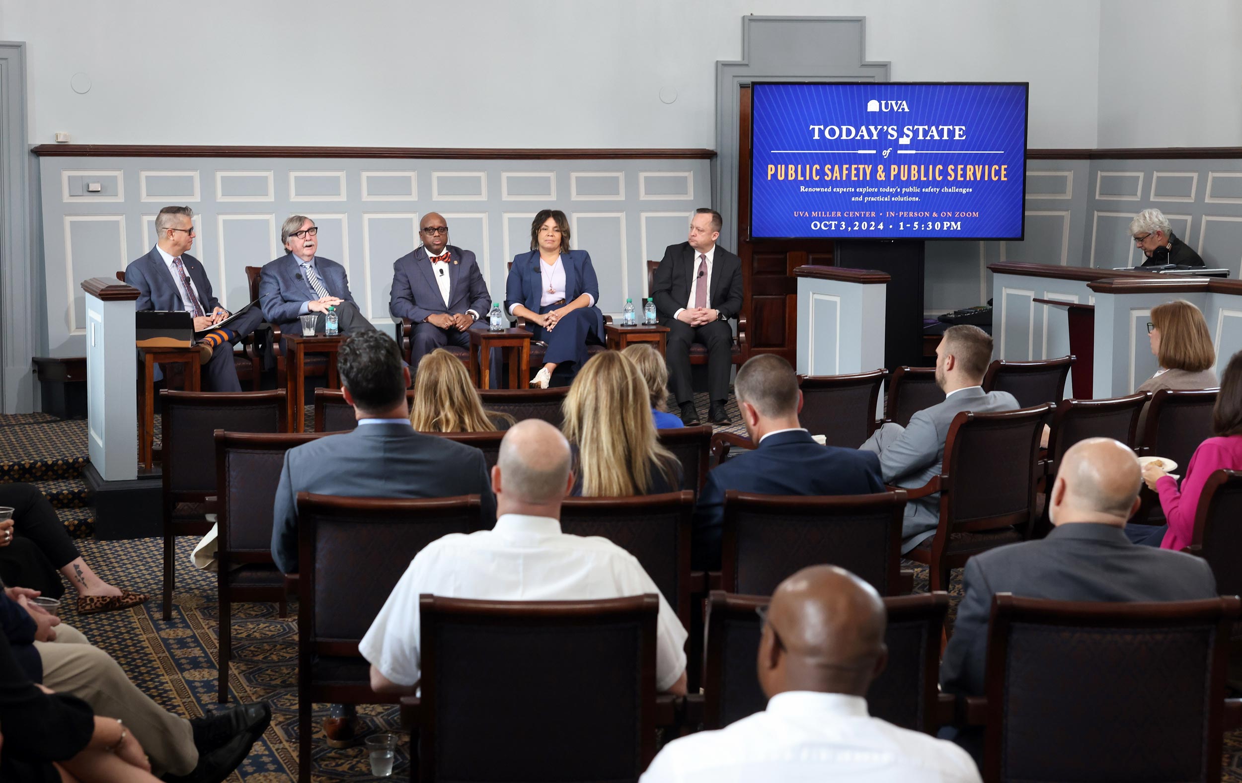 Group of people from The Center for Public Safety and Justice discussing public safety during an event at UVA's Miller Center.