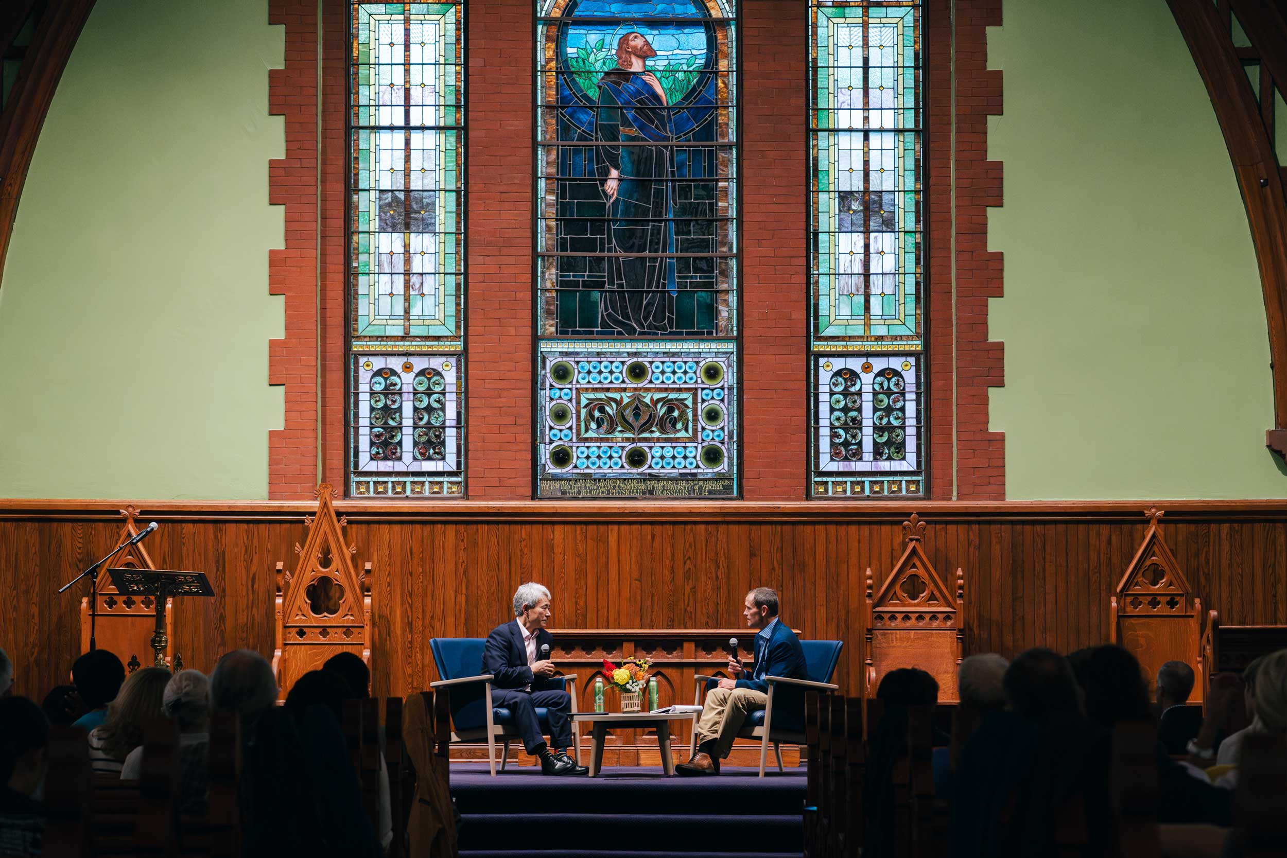 Walter Kim, left, president of the National Association of Evangelicals, speaks with UVA President Jim Ryan in the UVA Chapel 