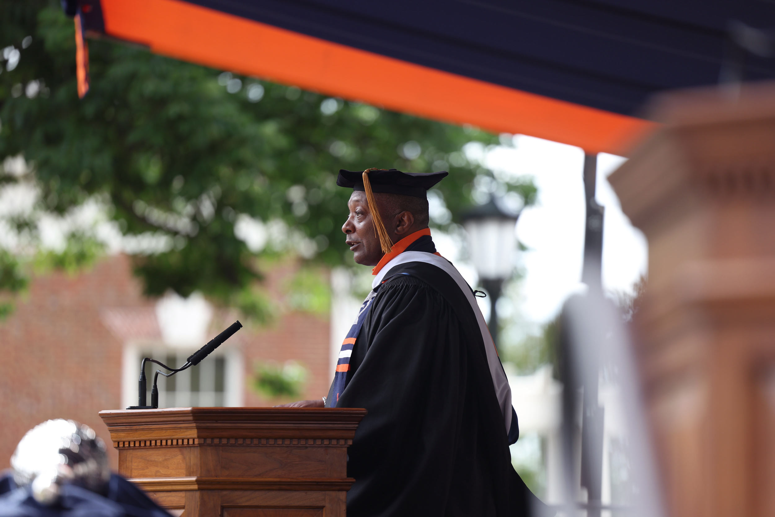Cedric Rucker at the podium giving the keynote at UVA‘s Final Exercises 2025