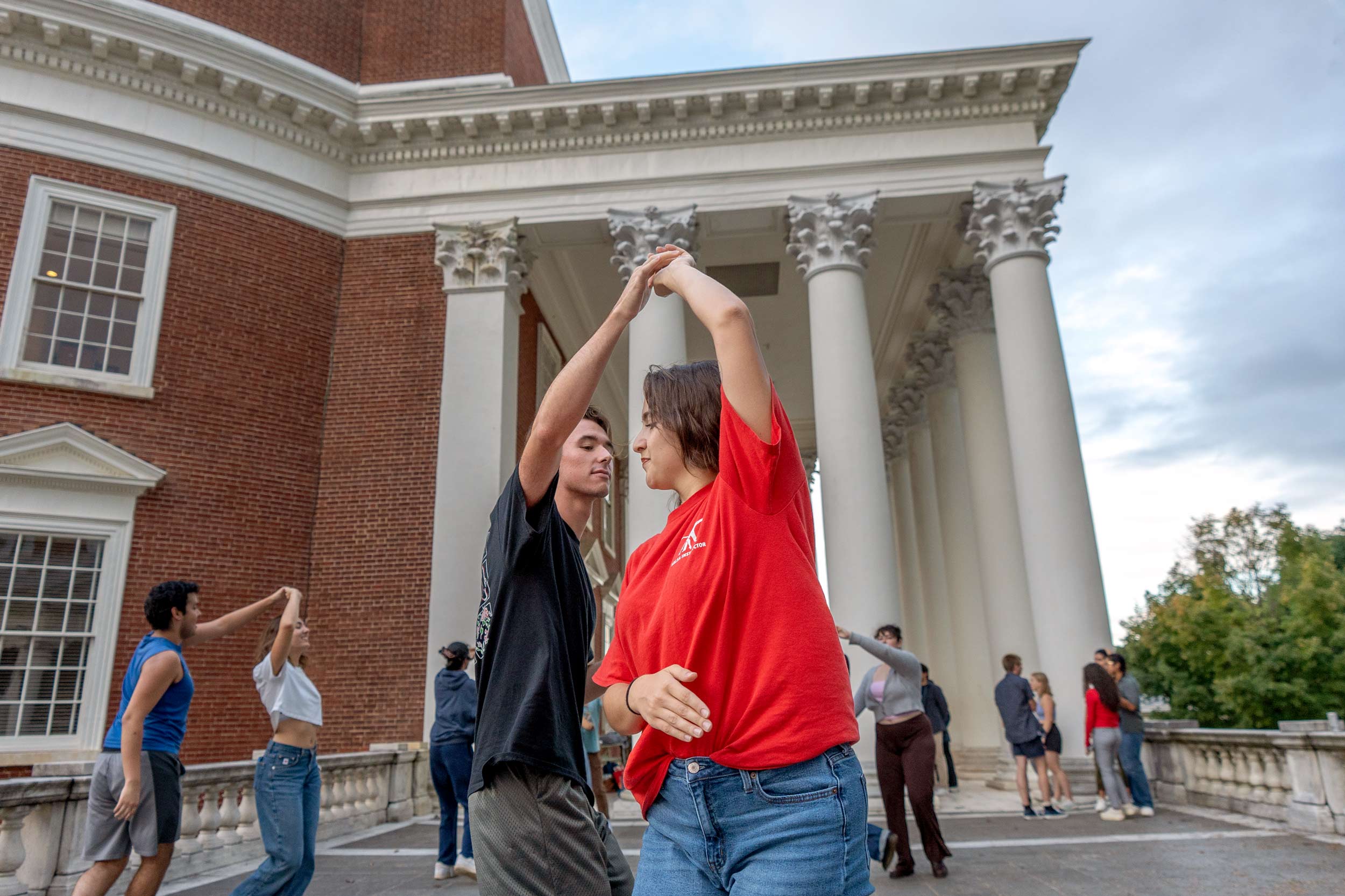 Dancers doing the salsa in front of the Rotunda pillars