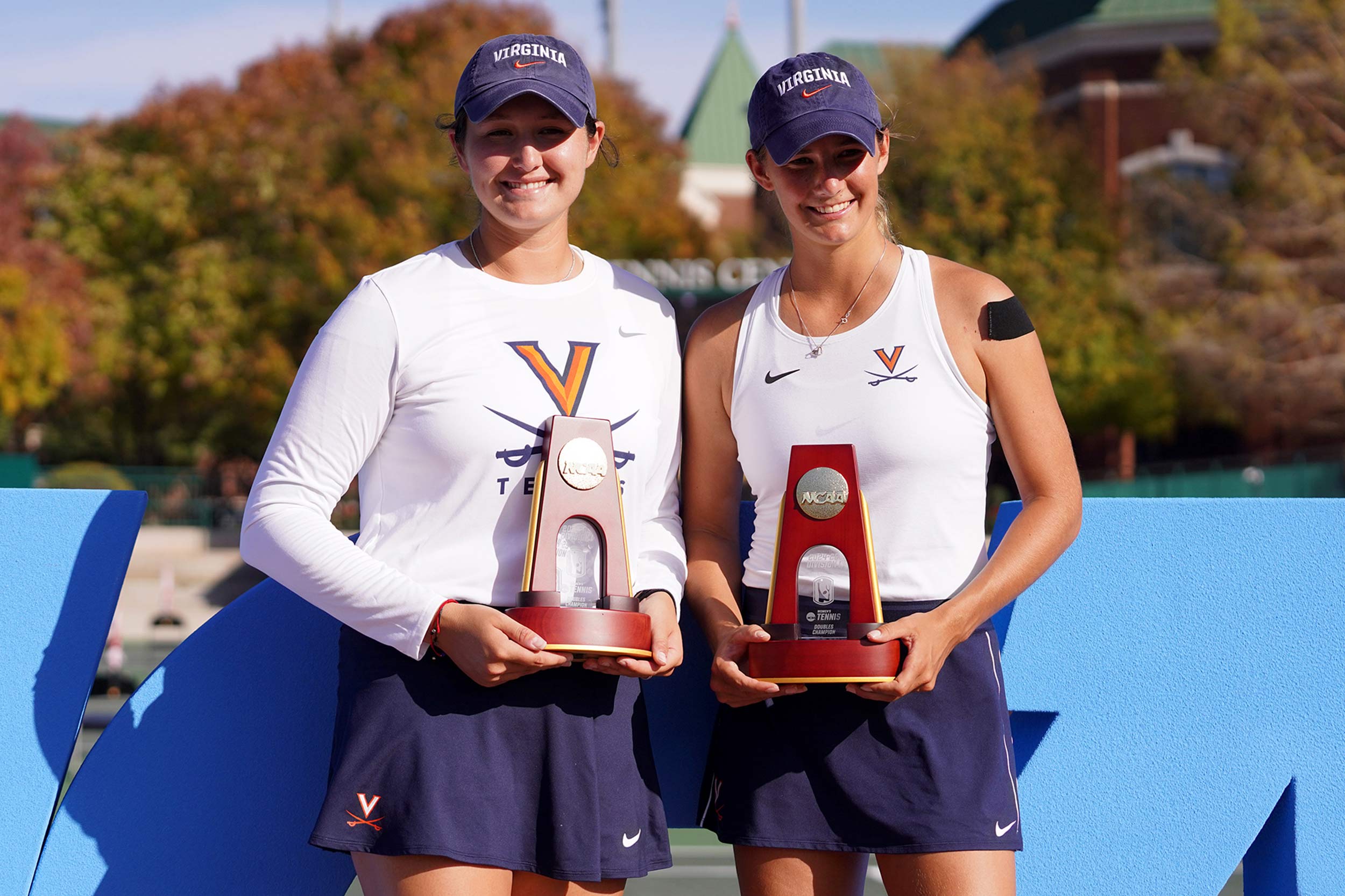 UVA’s Elaine Chervinsky and Melodie Collard holding the trophy 