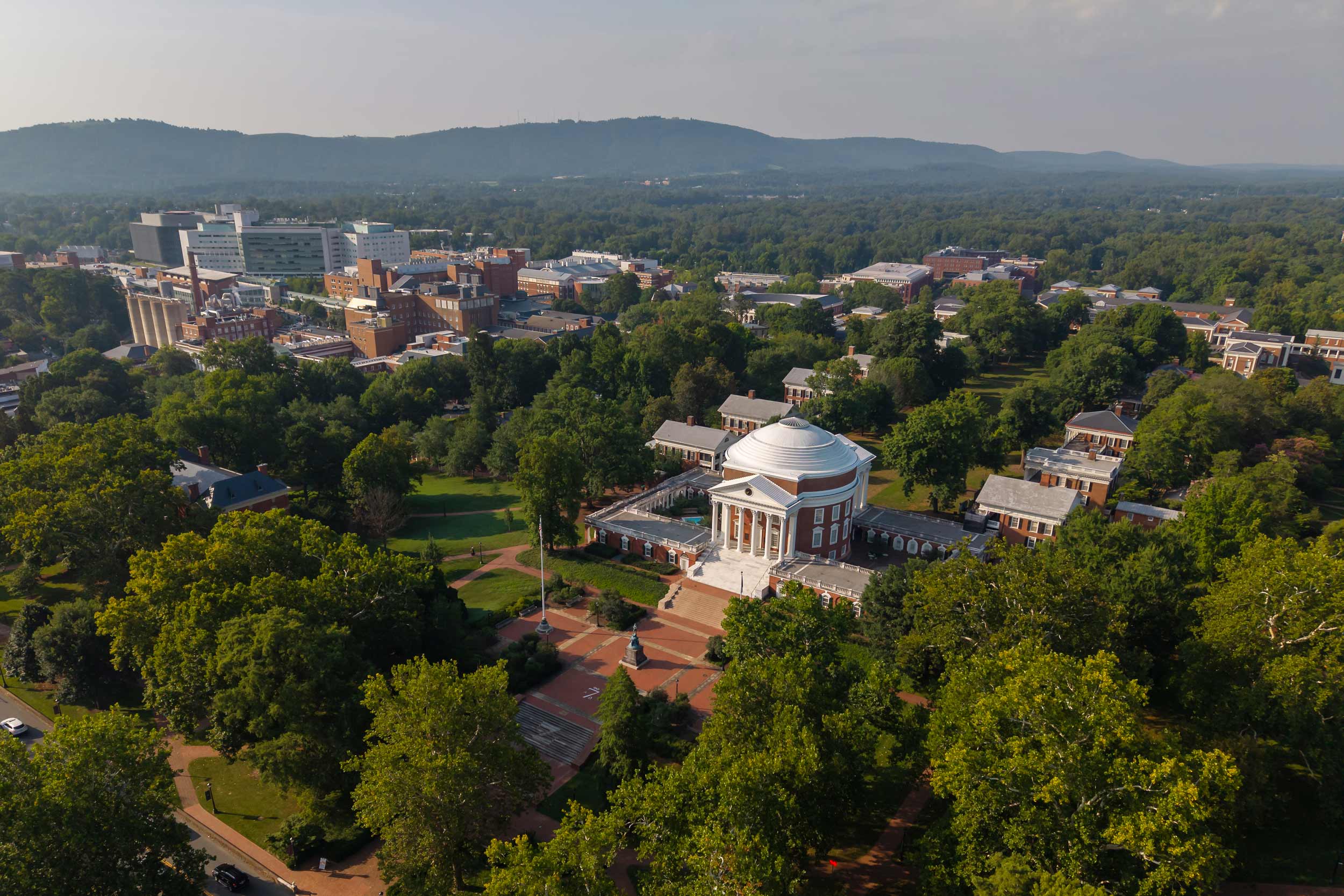 aerial photo of the UVA Rotunda, Academic Village, surrounding colleges and the UVA Medical Center shot in the late afternoon
