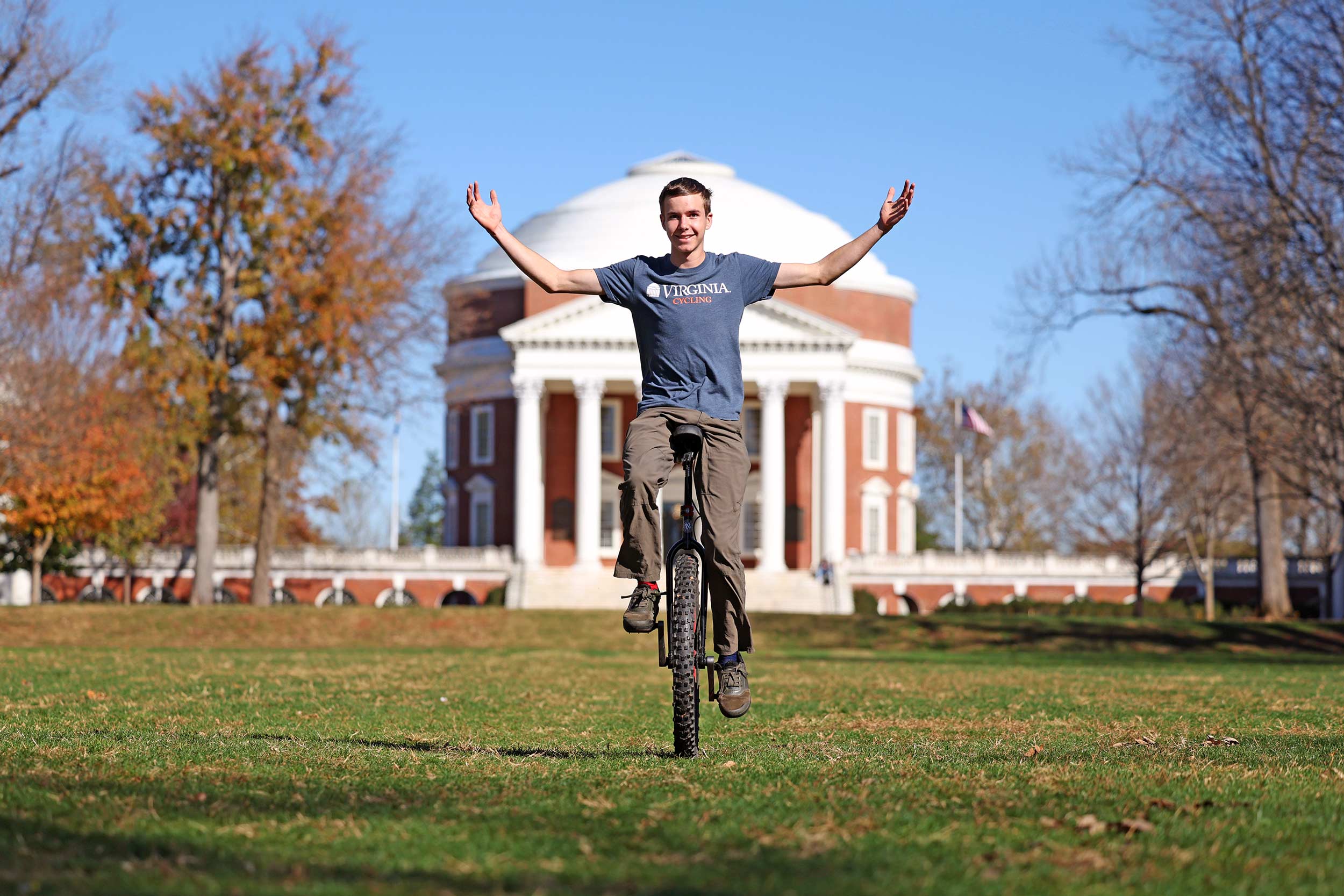 Mason Allen on his unicycle in front of the Rotunda on the Lawn