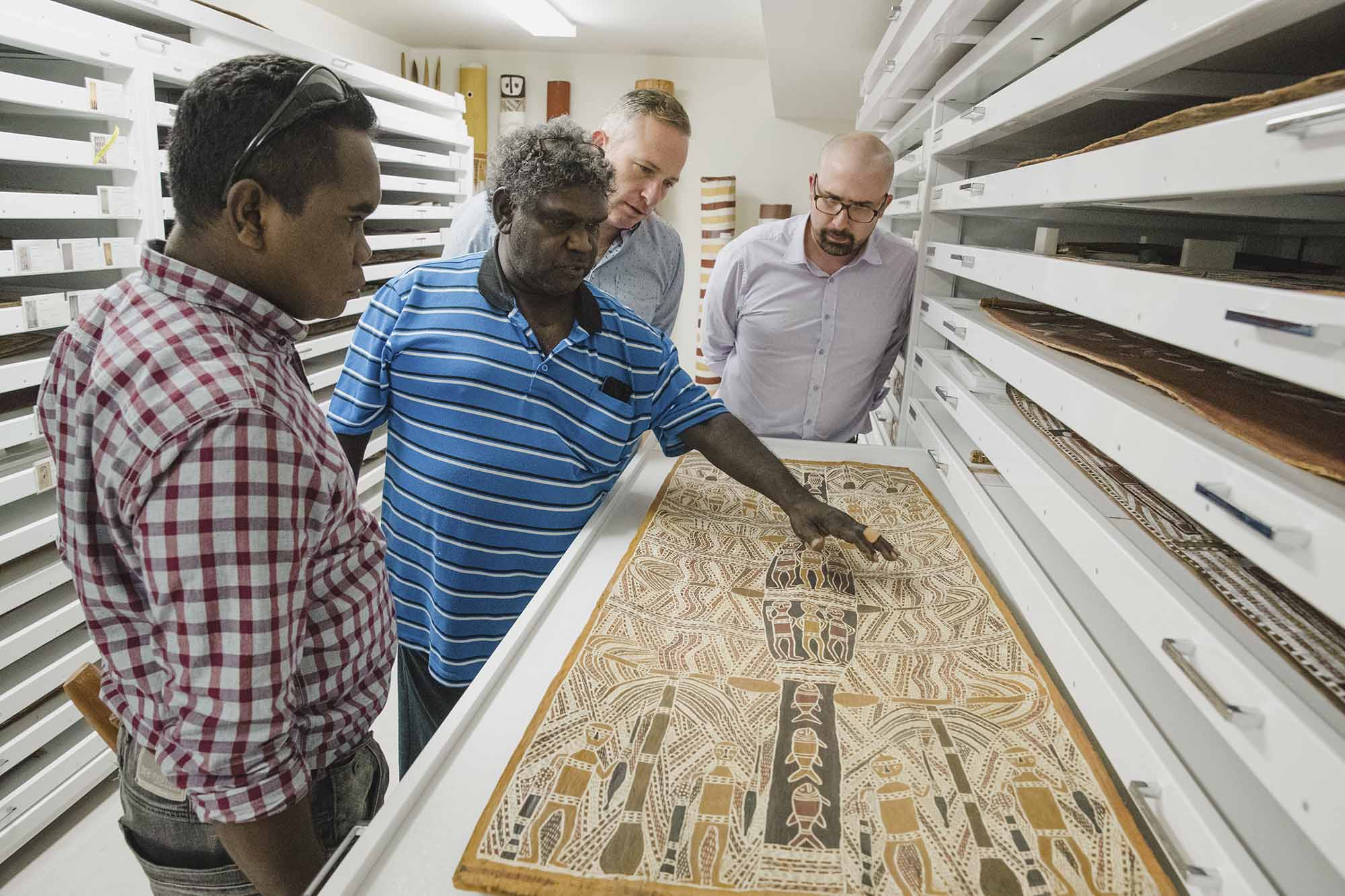 From left, curators Yinimala Gumana, Wukuṉ Waṉambi, Kade McDonald and Henry Skerritt look at an Aboriginal Art Collection item