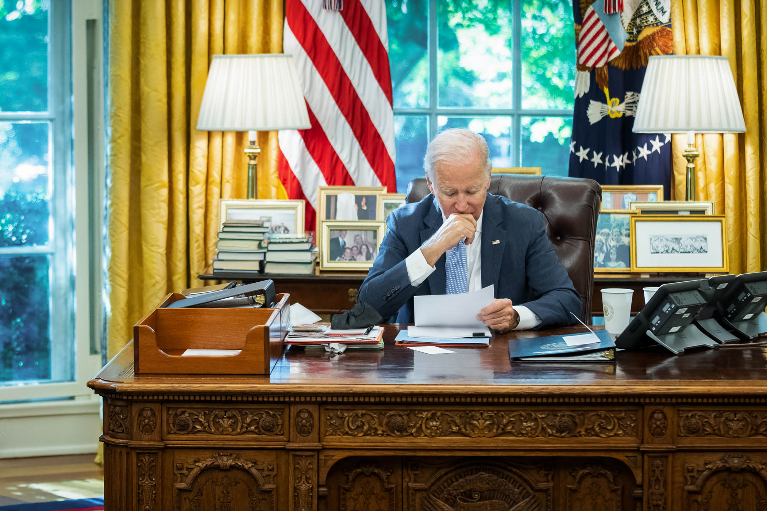President Joe Biden sitting in the Oval Office at his desk
