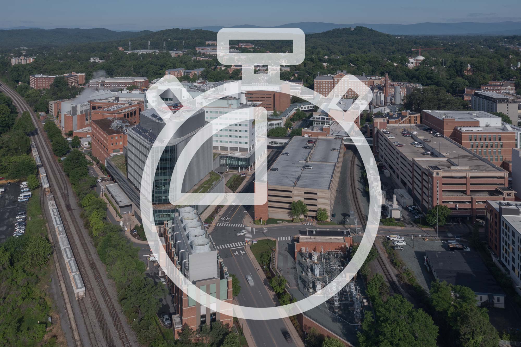 Illustration of a stopwatch over an aerial photo of the UVA Health System