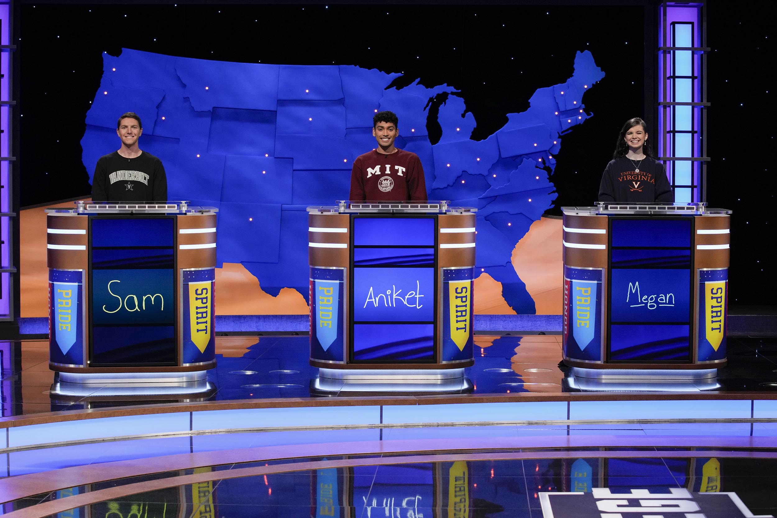 Three college students standing at the jeopardy podiums with UVA's Megan Sullivan on the right