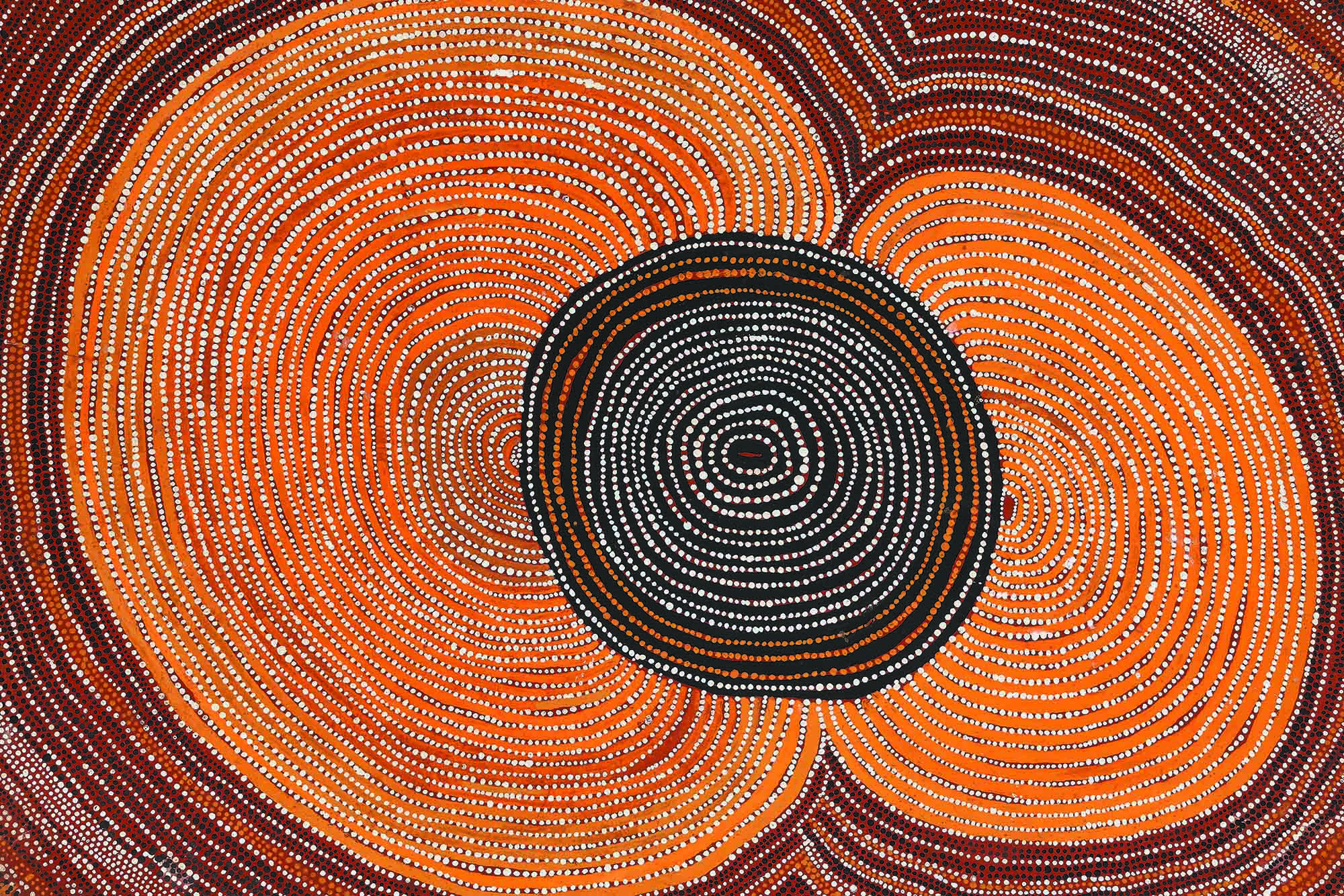 Shorty Lungkarta Tjungurrayi’s painting: oranges, reds, browns, and yellow dots in circle formation