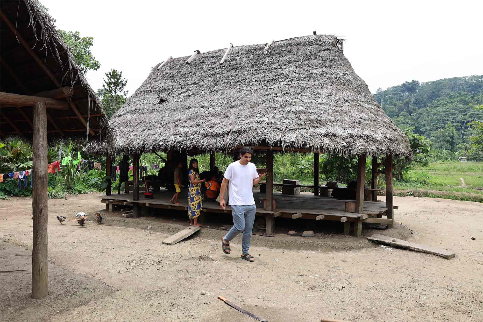 Jackson Khandelwal in front of hut in Ecuadorian village