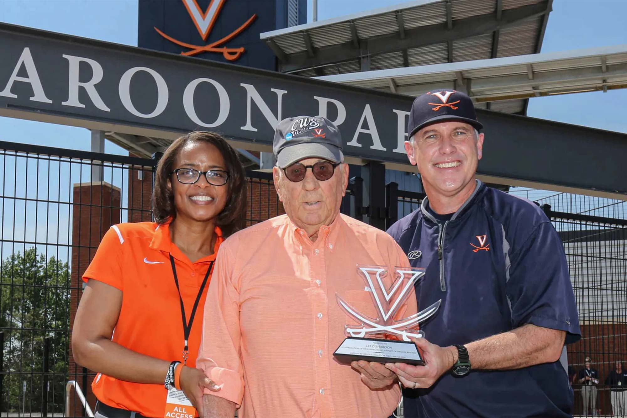 Portrait of Leslie B. Disharoon, center, with UVA Director of Athletics Carla Williams, left, and Cavalier baseball coach Brian O’Connor