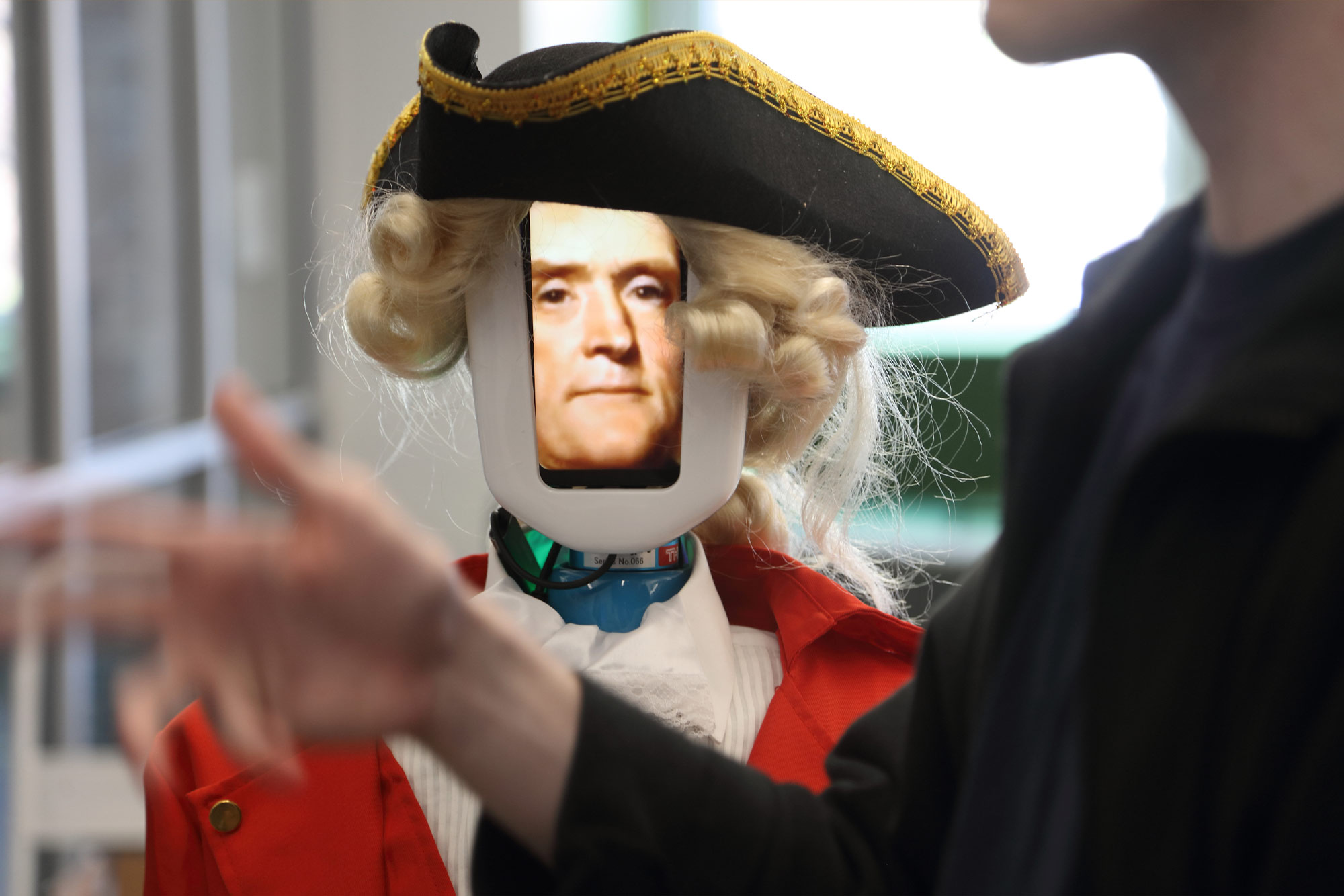 Student giving demo of Thomas Jefferson in robot form