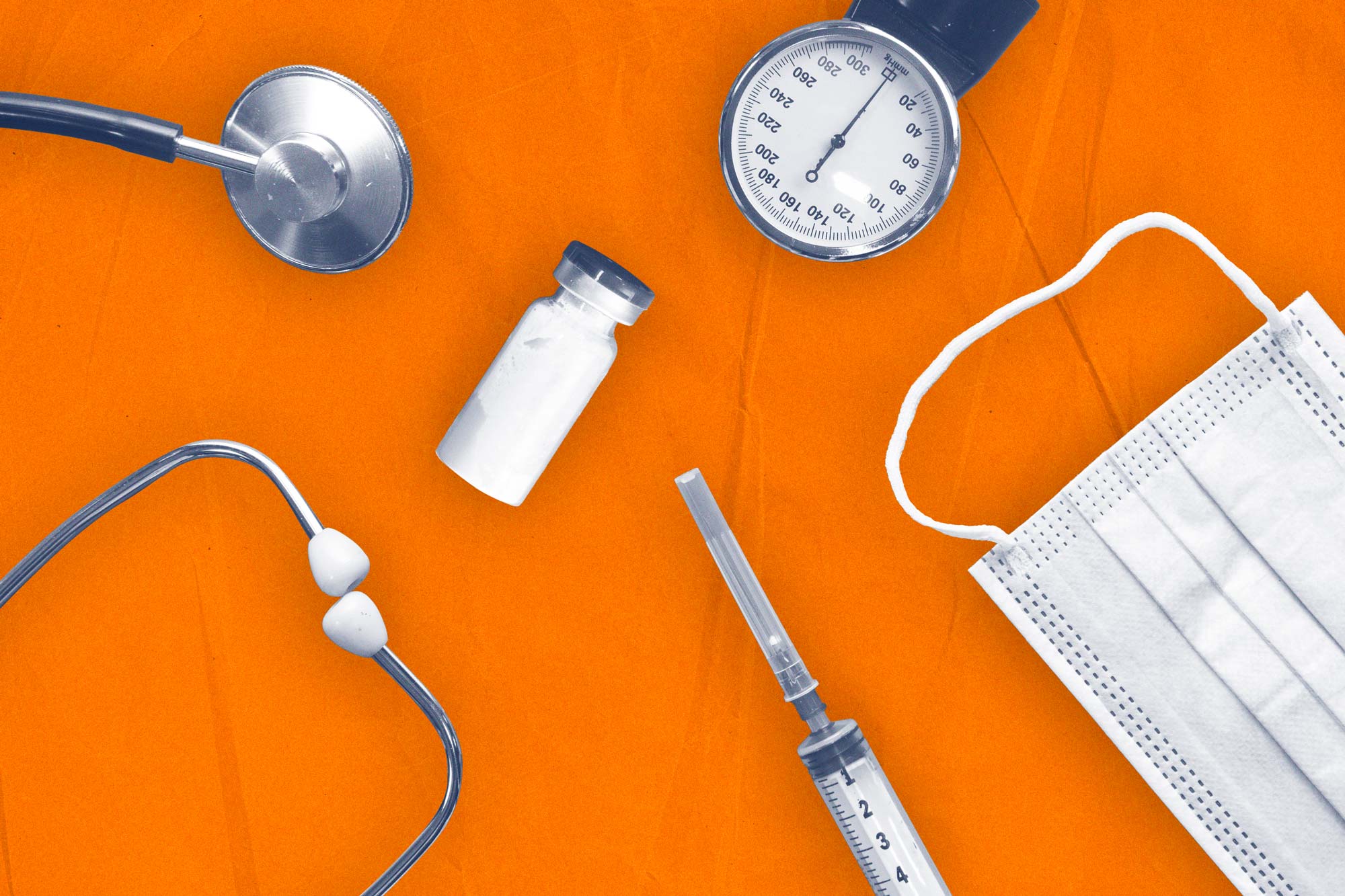 Stethoscope, medicine bottle, administering needle blood pressure meter and face mask on an orange background