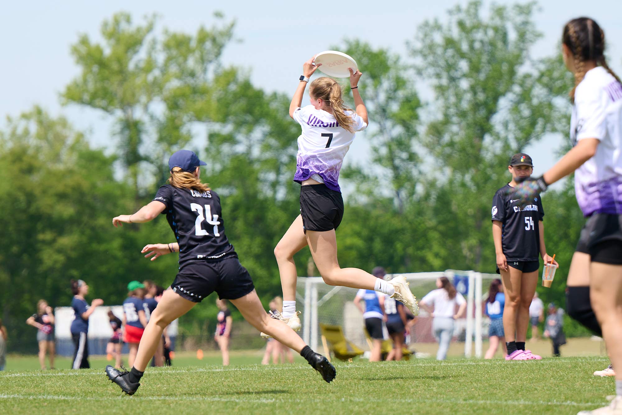 Action shot of a player jumping and catching a frisbee in mid air