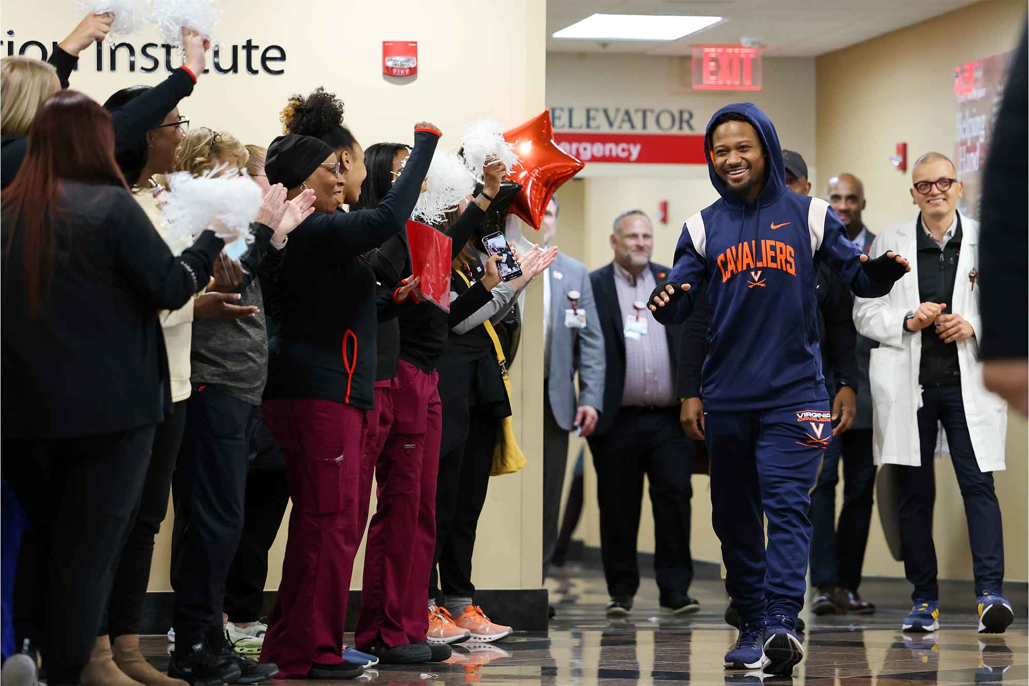Perris Jones leaving the hospital with a crowd applauding his recovery 
