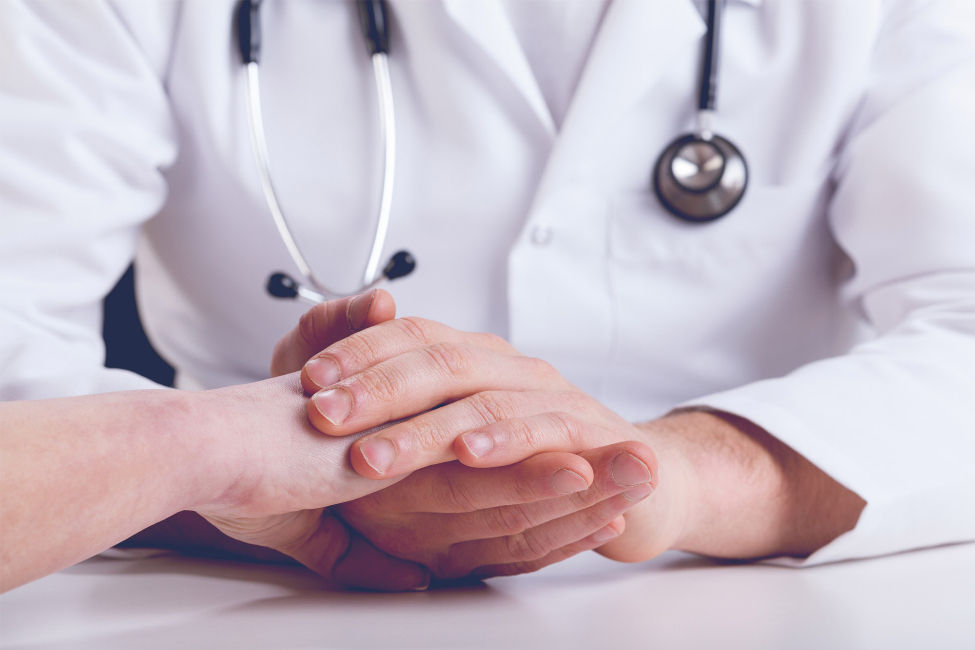 Doctor holding patient's hand stock image