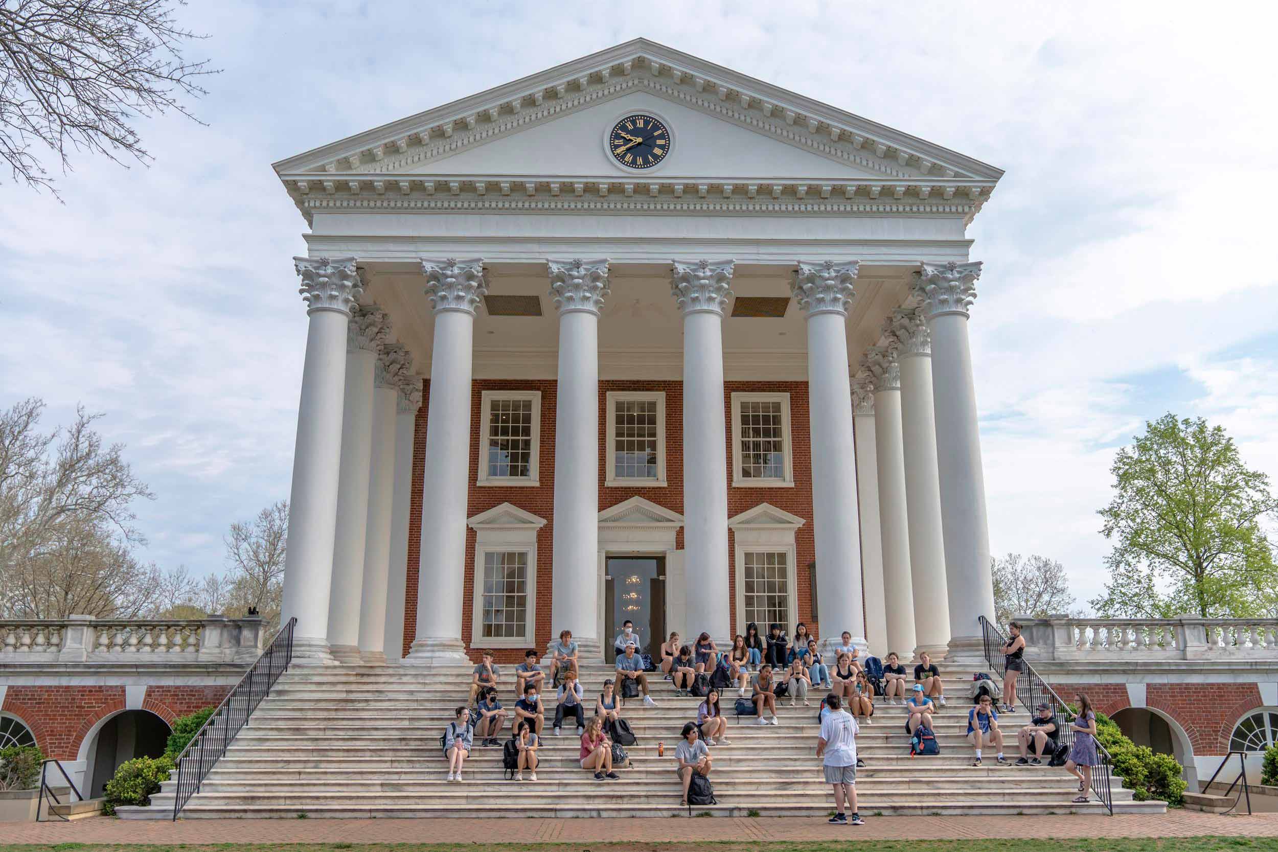 Picture of students sitting on the steps of the Rotunda