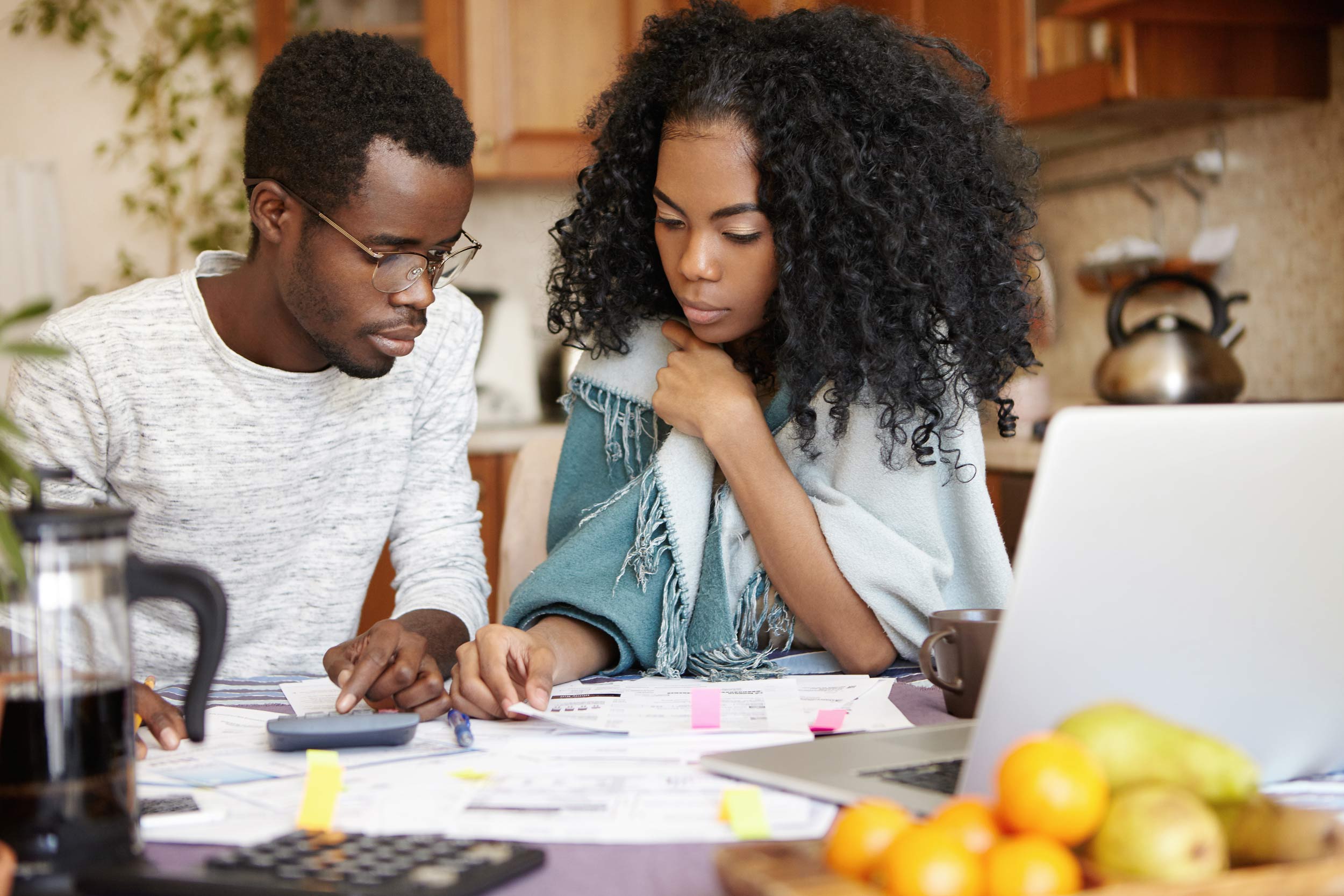 A couple sits down to look at financial papers together