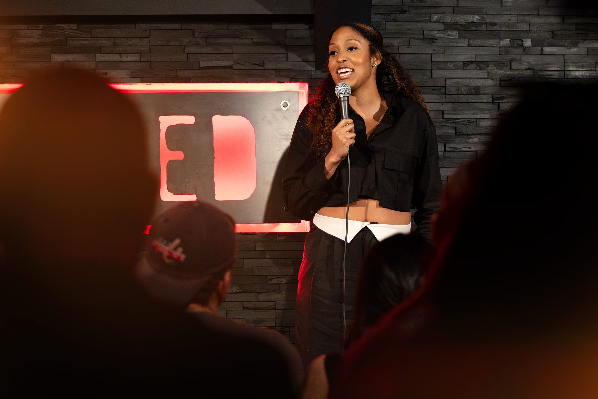 Jasmine Burton, a highly decorated UVA volleyball player and 2017 graduate, on stage during a comedy show of hers.