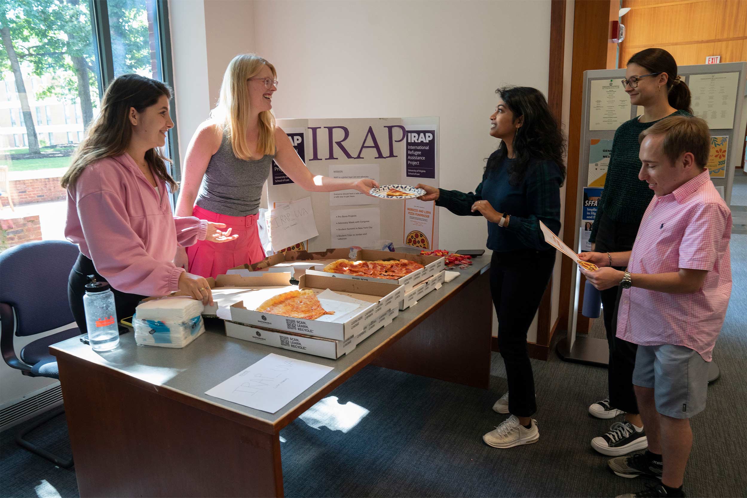 Students serving pizza