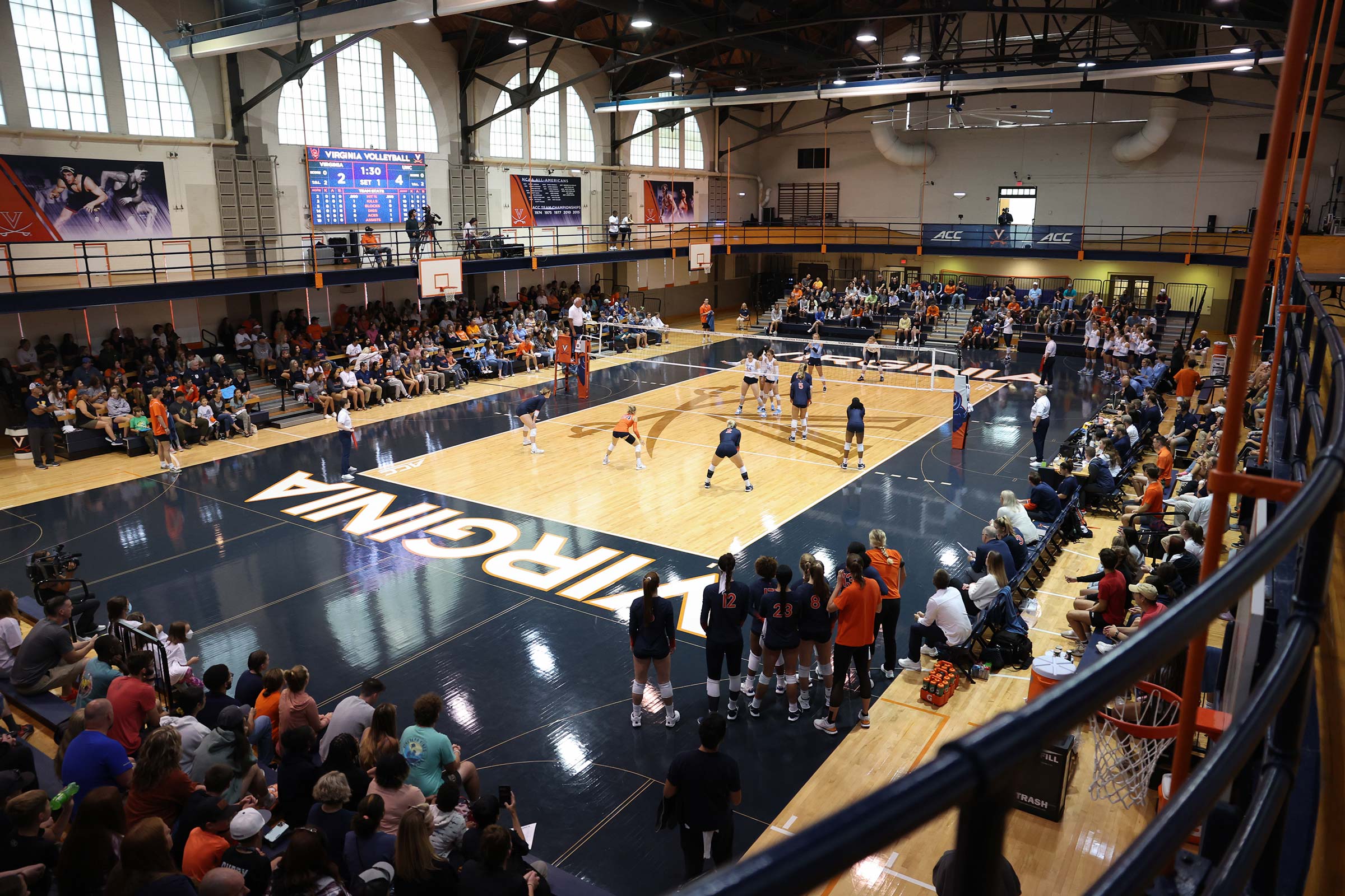 Portrait of the UVA volleyball team practicing.