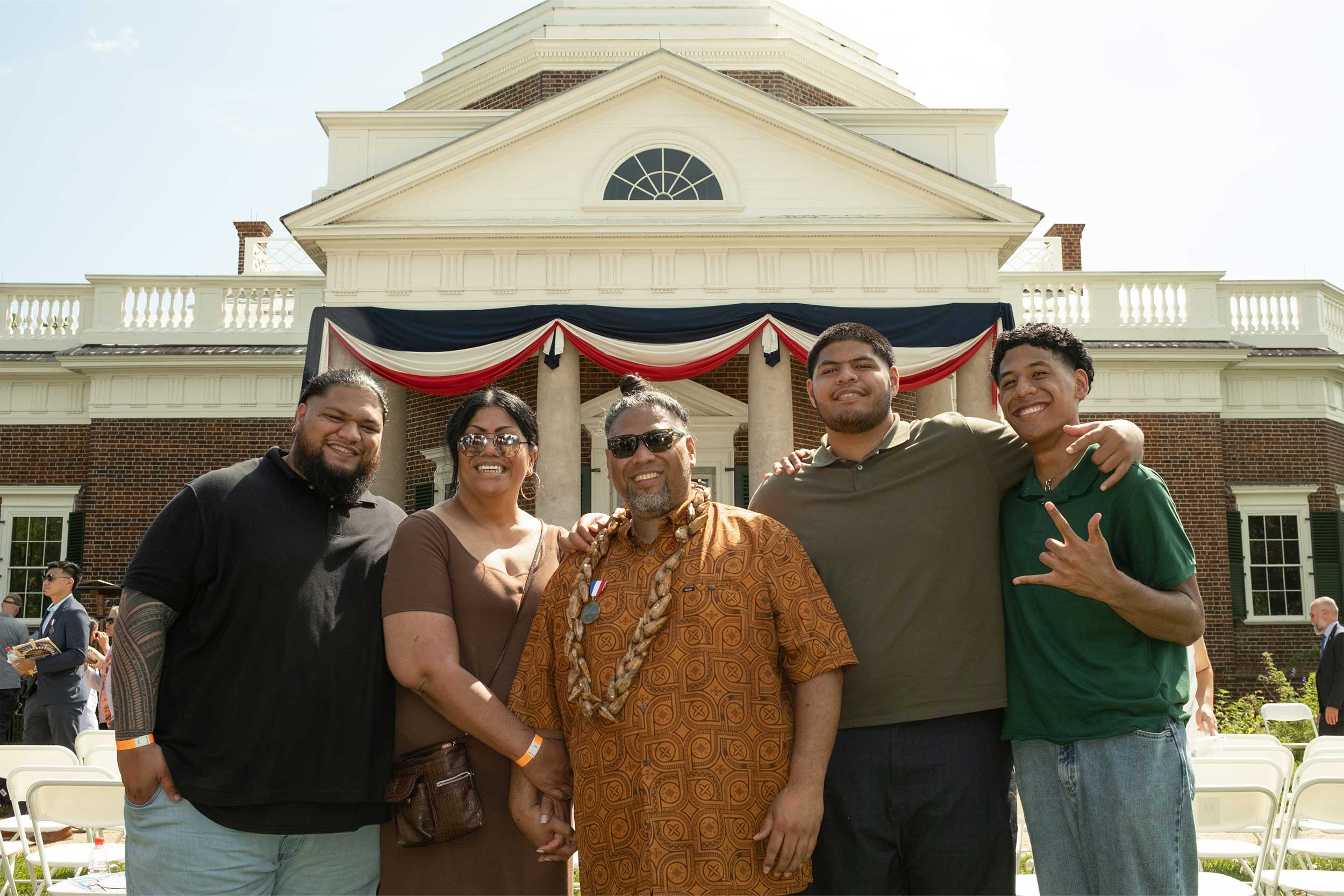 Sui Amaama, center, and his family, wife Isabelle, sons Snoop, Dogg and Slim standing in front of Monticello at the end of the naturalization ceremony.