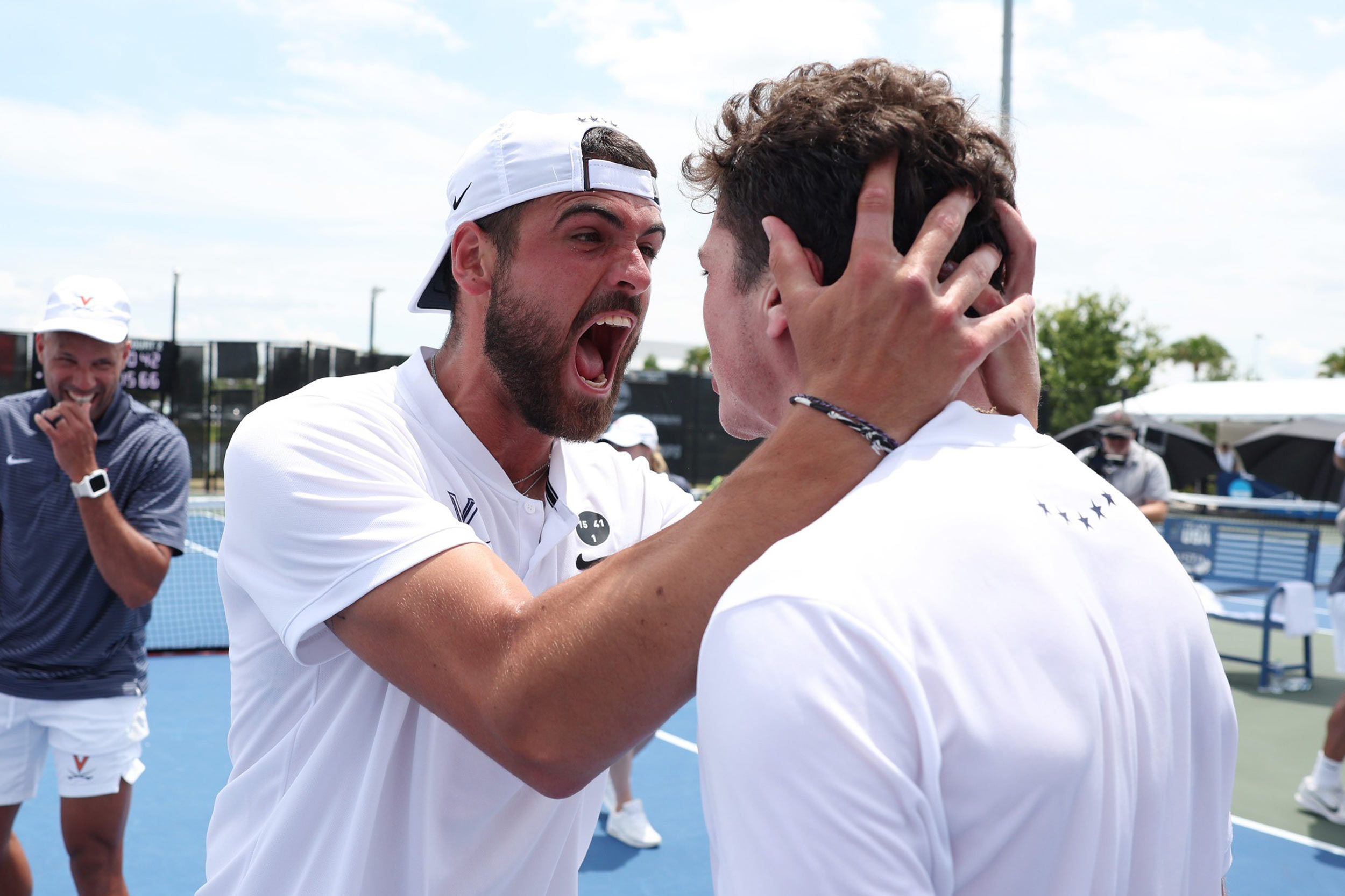 Tennis player attempts to take a bite out of a teammate