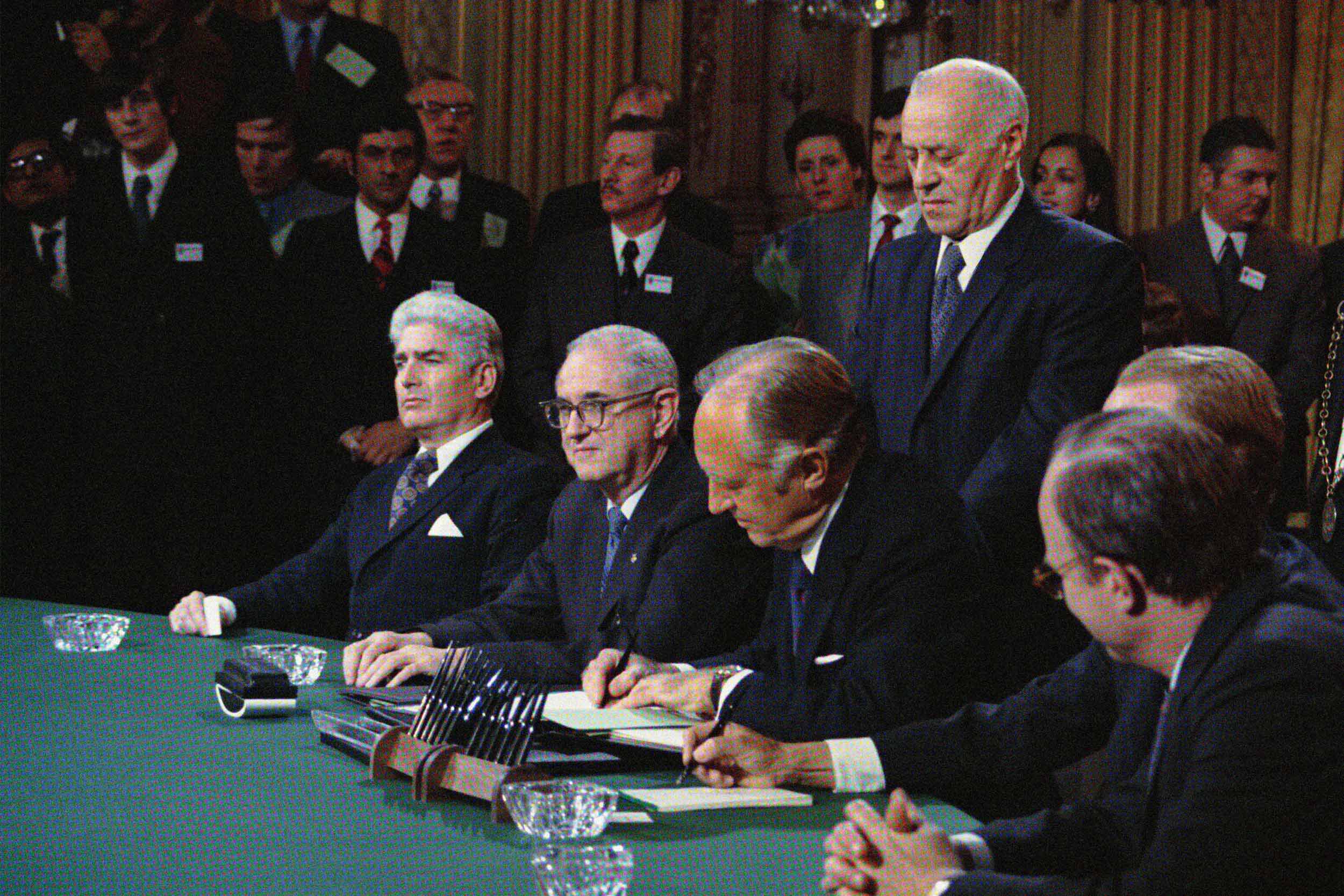 U.S. representatives signing a treaty at a press conference in 1973
