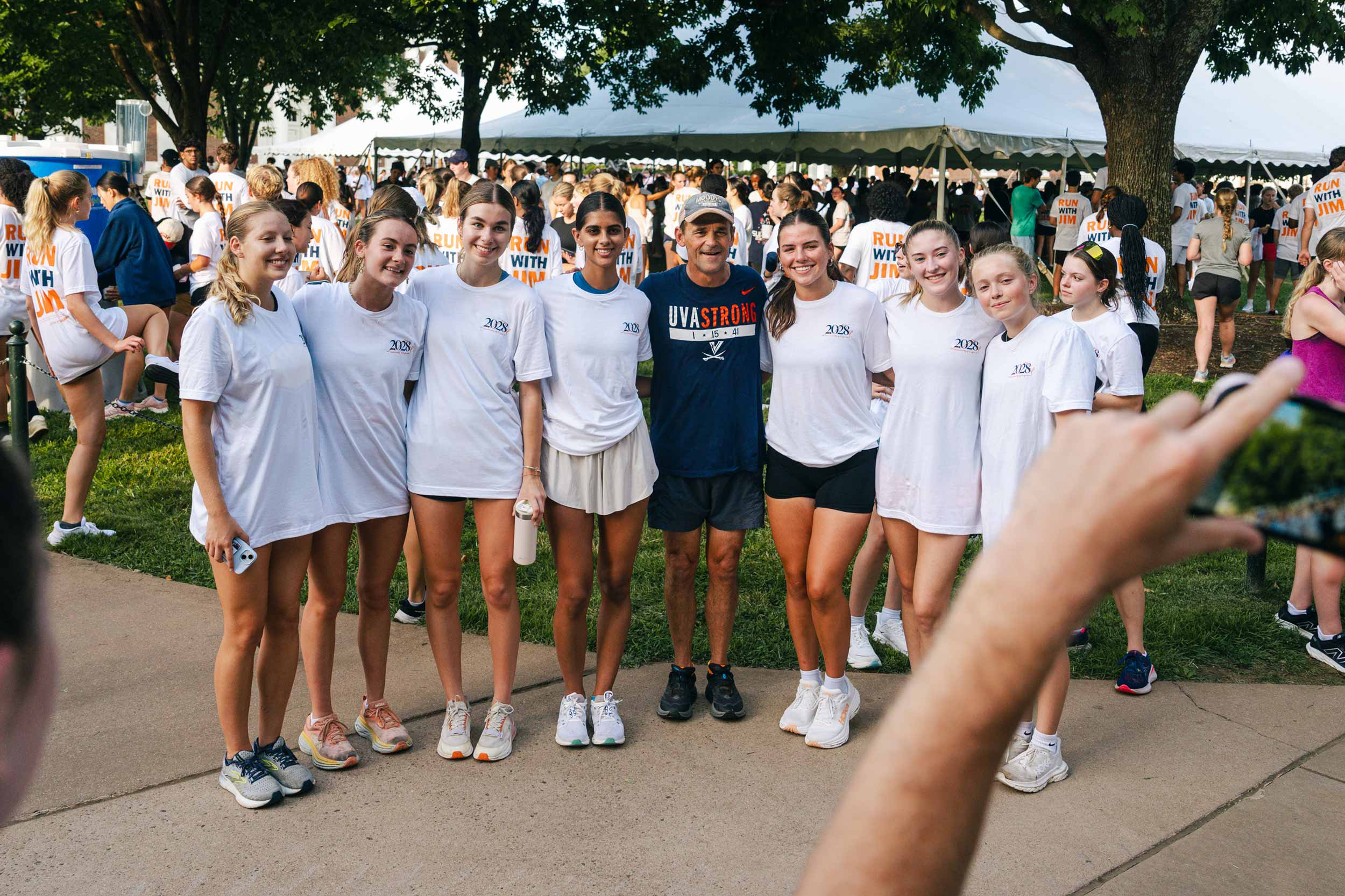 A group of students stand with President Ryan after doing the first "Run with Jim" of the year