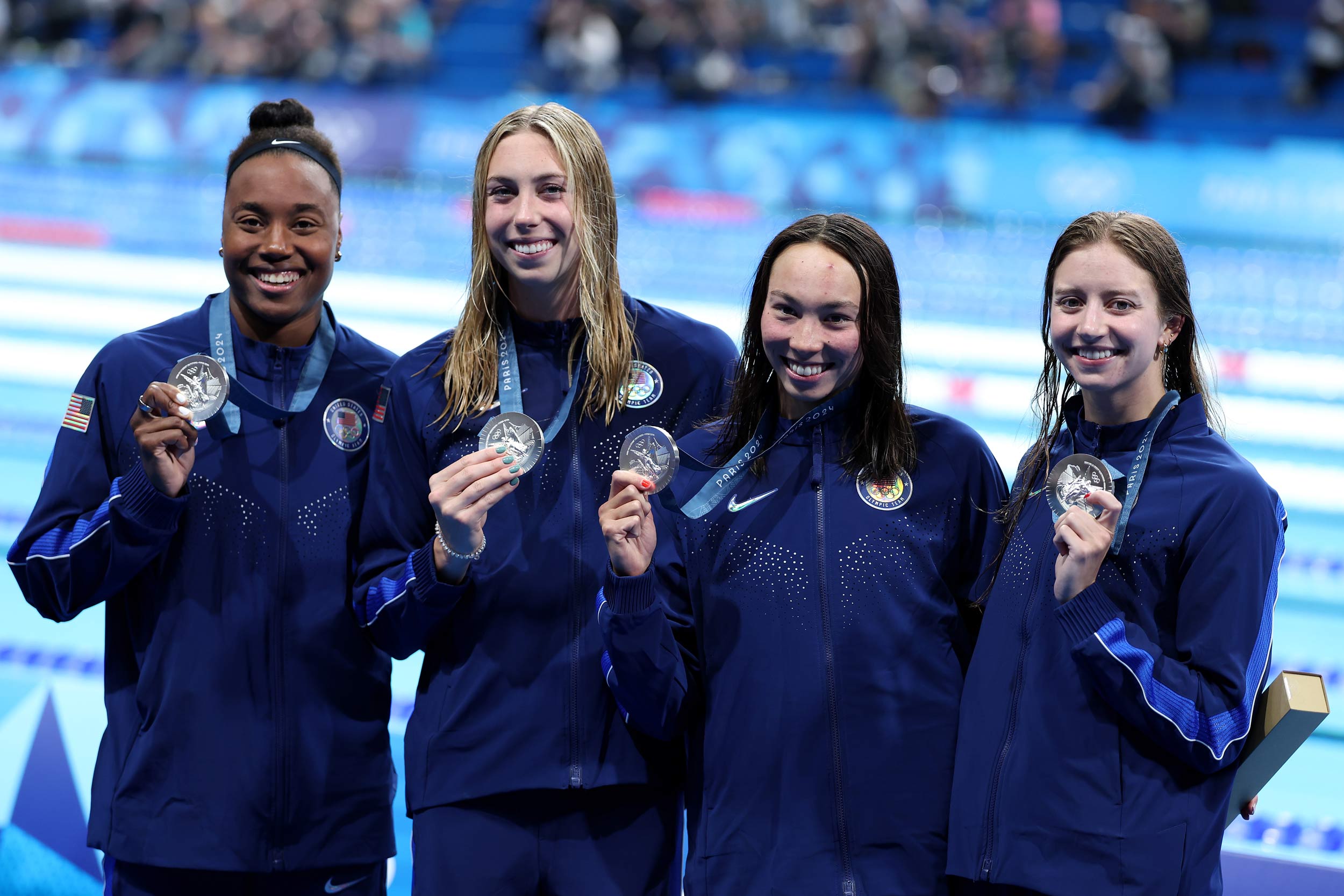 Simone Manuel, Gretchen Walsh, Torri Huske and Kate Douglass showcase their silver medals after Saturday’s performance in the 4x100-meter freestyle relay. 