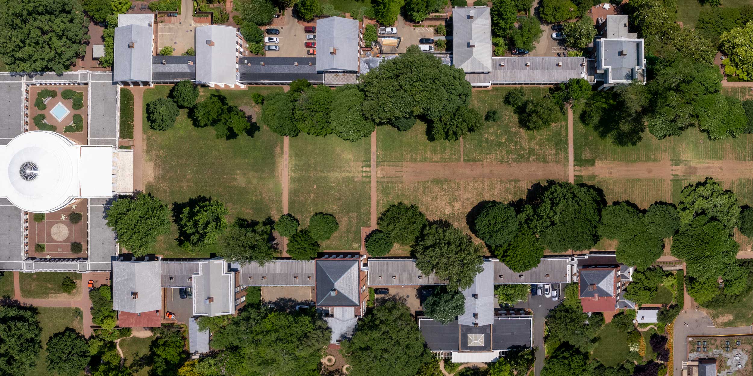 Aerial photo showing the Lawn with grass worn away and muddy from the Rotunda on the left and Old Cabell Hall on the right